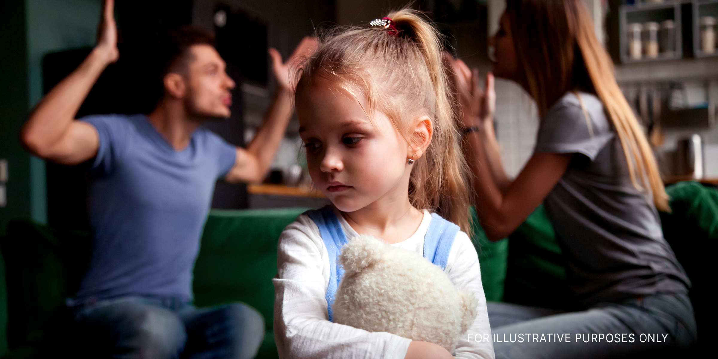 Girl feeling sad while her parents have an argument | Source: Shutterstock