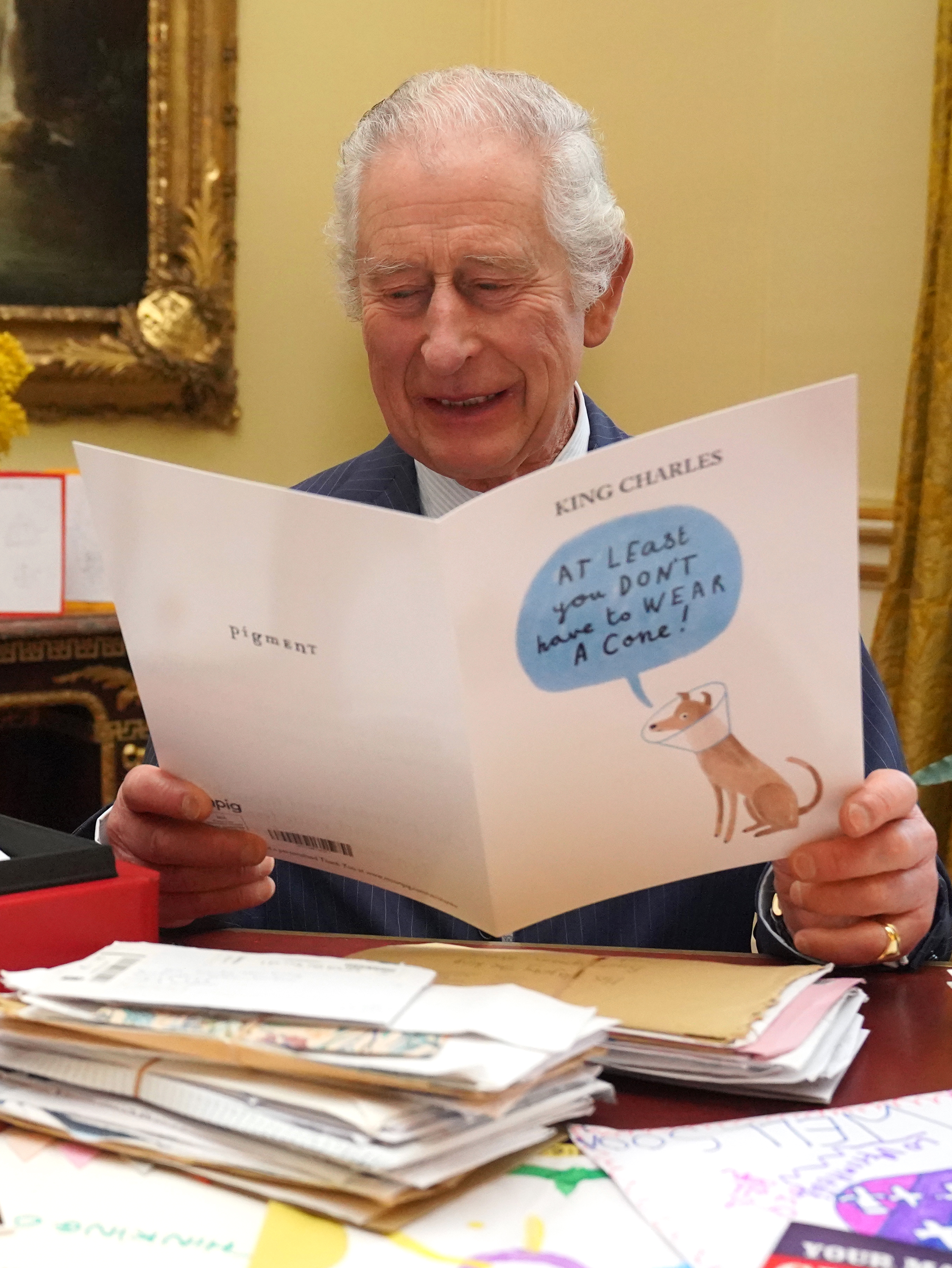 King Charles III reading cards and messages sent by well-wishers following his cancer diagnosis in a photo released on February 23, 202  | Source: Getty Images