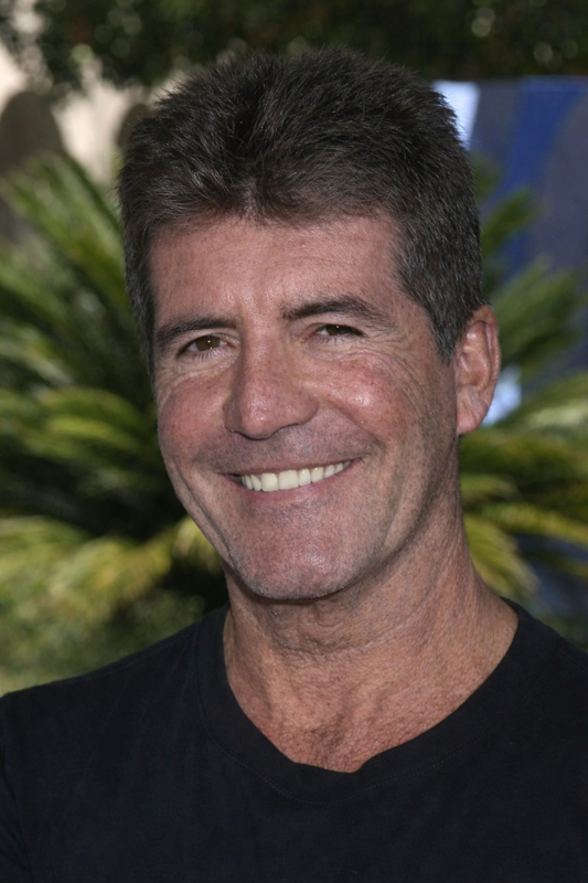 Shot outdoors against a backdrop of tropical greenery, he flashes a wide smile, the skin tanned and lightly textured, with natural creasing around the eyes. | Source: ChatGPT