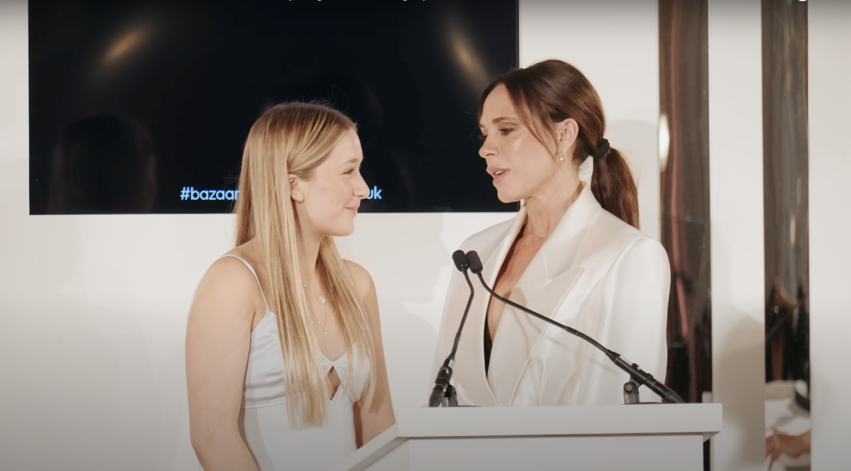 Harper and Victoria Beckham on-stage at the Harper's Bazaar's awards event, as seen in a video posted on November 7, 2024 | Source: YouTube/harpersbazaaruk