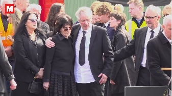 Enya and Pól Brennan supported one another as they walked alongside mourners during the funeral in a post dated 17 April 2026. | Source: Instagram/irishmirror
