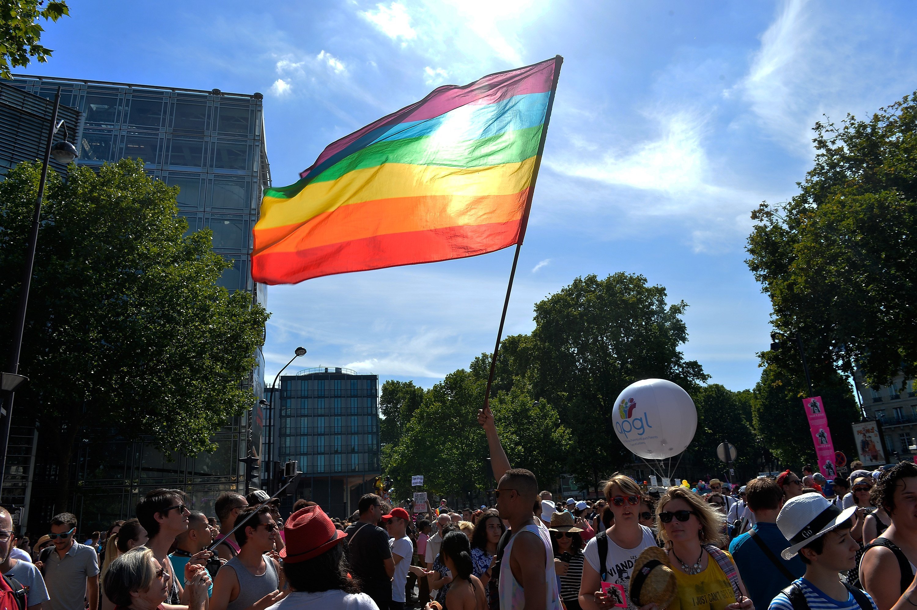 A rainbow flag being waved at the Gay Pride Parade in Paris | Photo: Getty Images