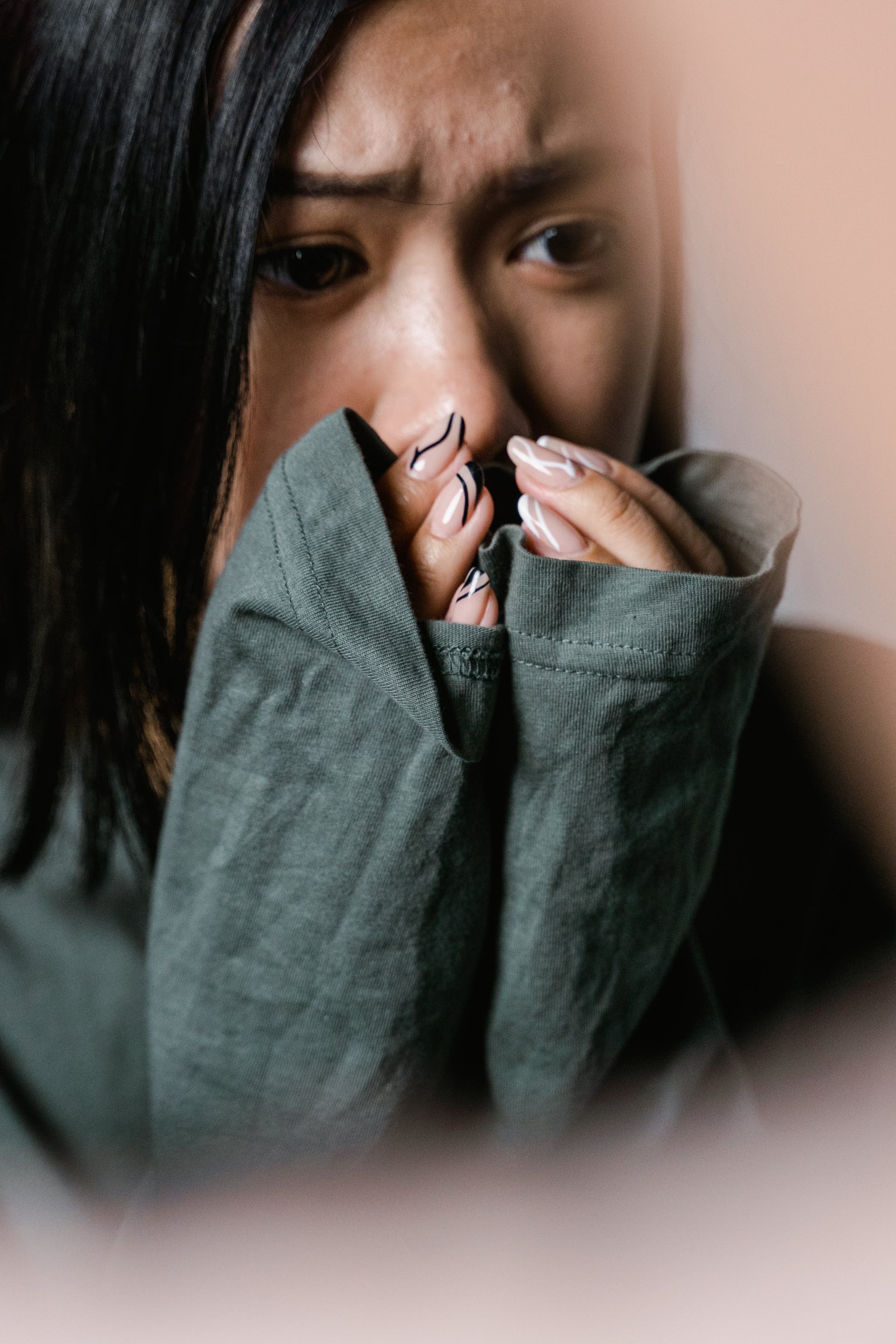 A woman covering her mouth in shock | Source: Pexels