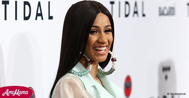 Cardi B confirms her pregnancy as she flaunts her growing baby bump in a skin-tight white dress