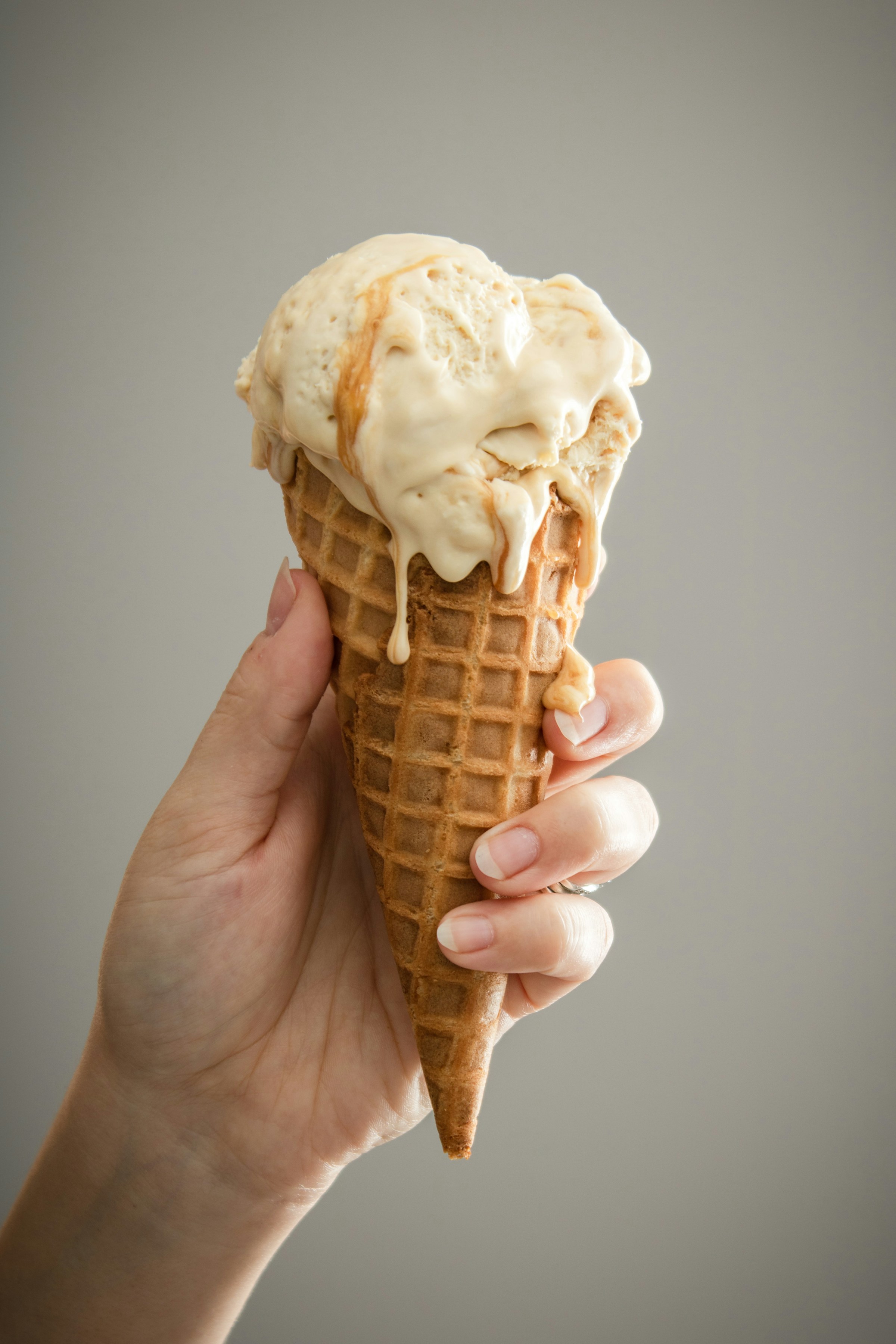 A person holding an ice cream cone | Source: Unsplash