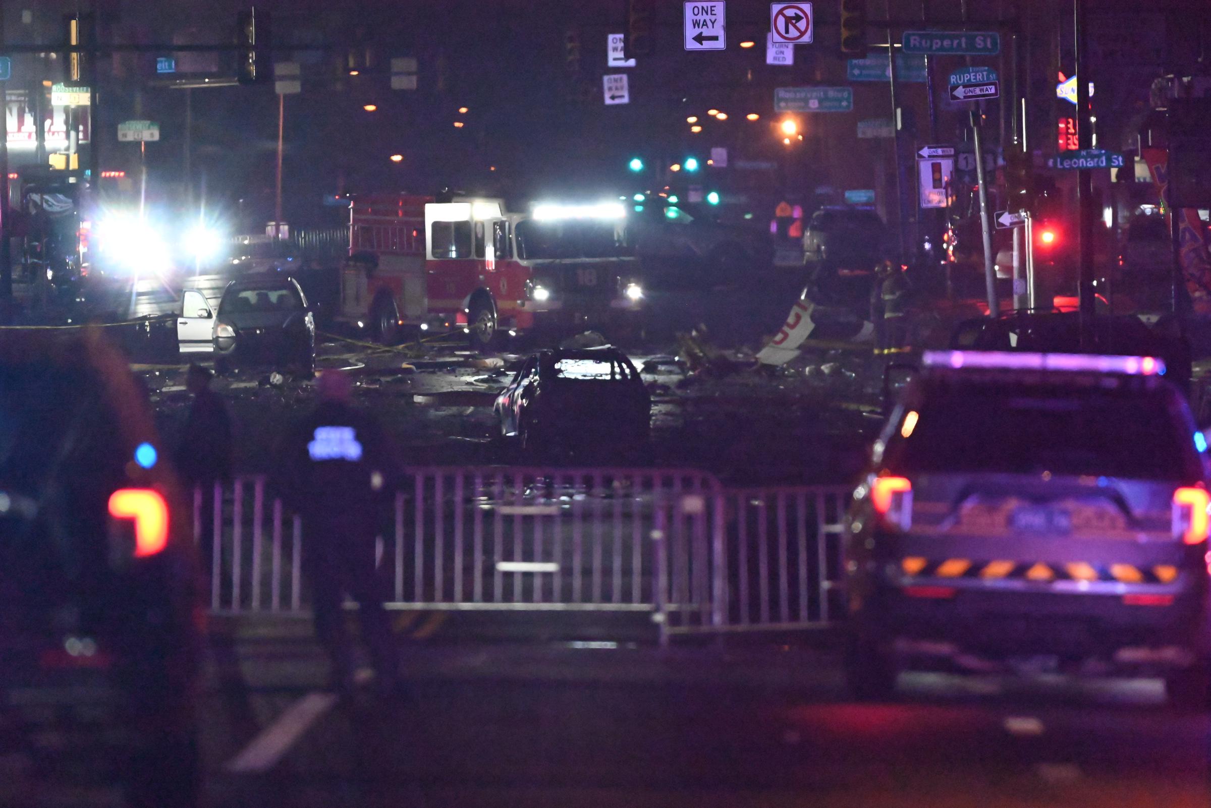 A barricade, police car and first responders in front of the plane crash site on February 1, 2025. | Source: Getty Images