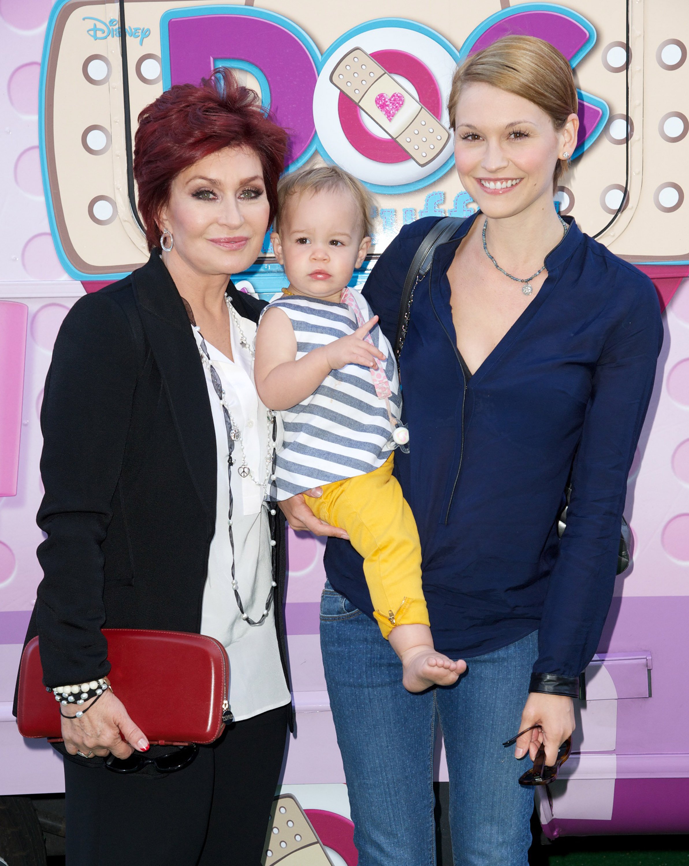 Sharon Osbourne, granddaughter Pearl and daughter-in-law Lisa Stelly attend Disneys Juniour's "Doc McStuffins Doc Mobile" at The Grove on 26 September 2013 in Los Angeles, California. | Source: Getty Images