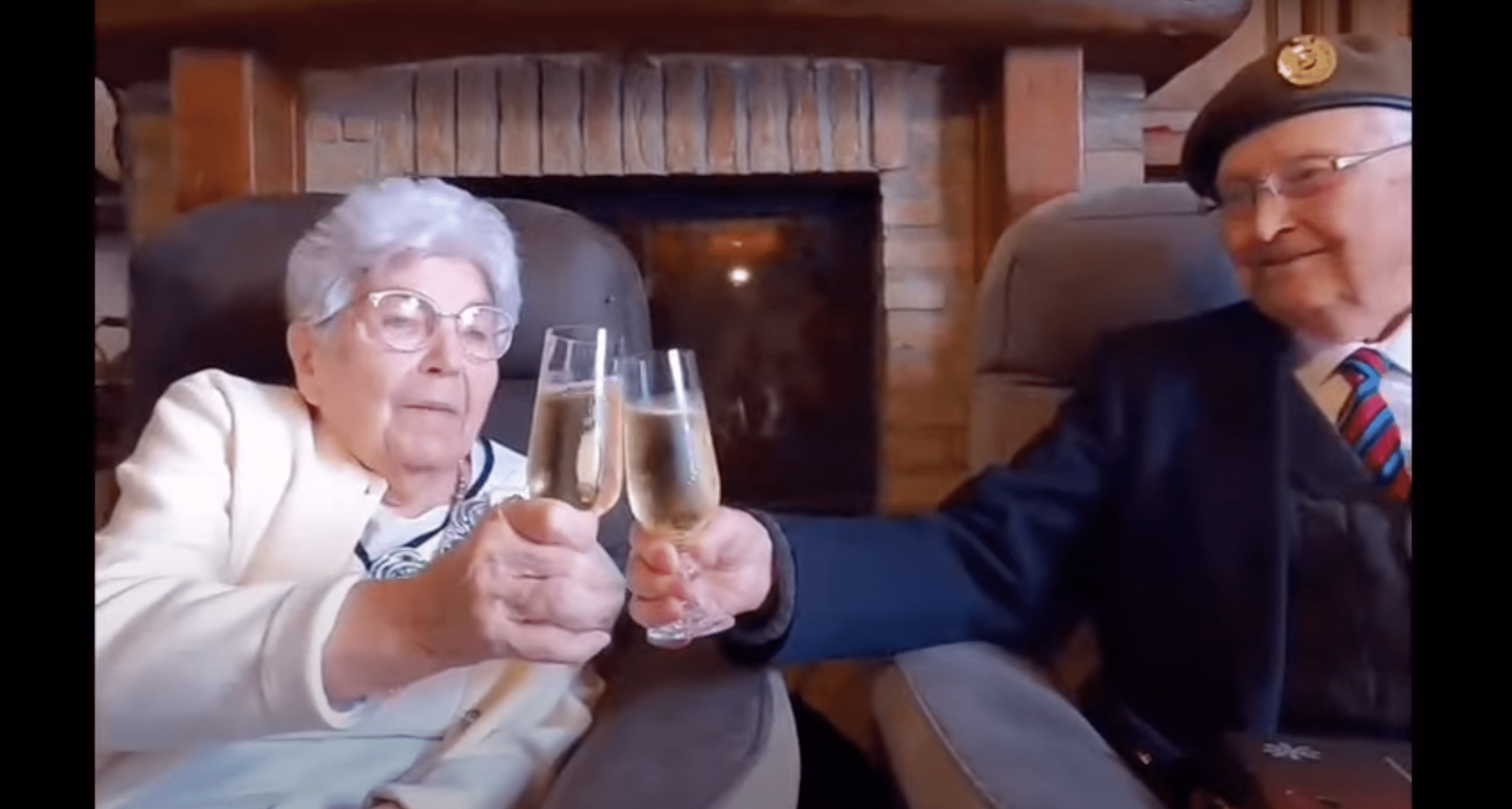 Huguette and Reg Pye share champagne. | Source: YouTube.com/Taxi Charity