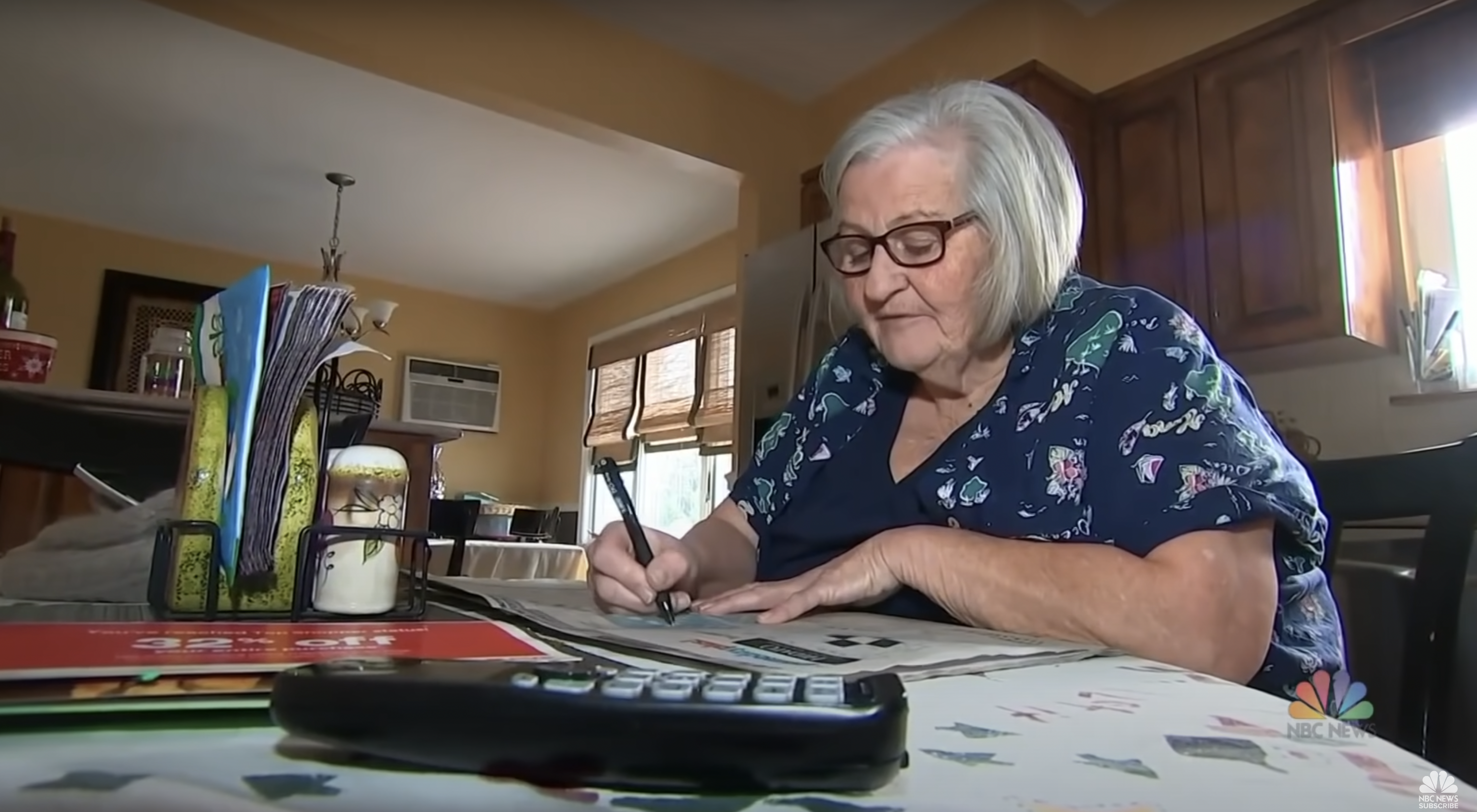 Jean Ebbert doing admin work at home. | Source: YouTube/NBC News