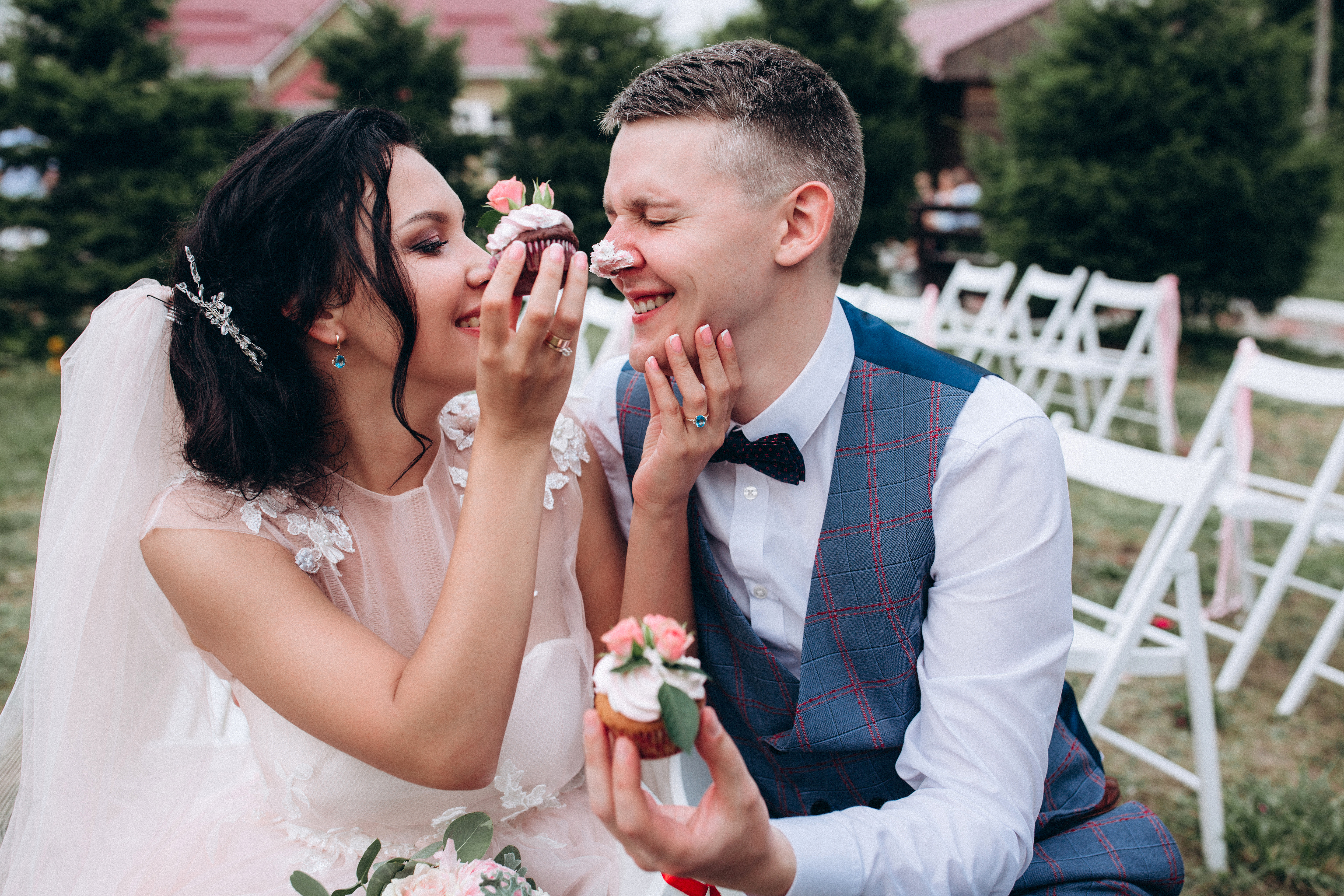 Bride placing icing on groom's nose | Source: Shutterstock