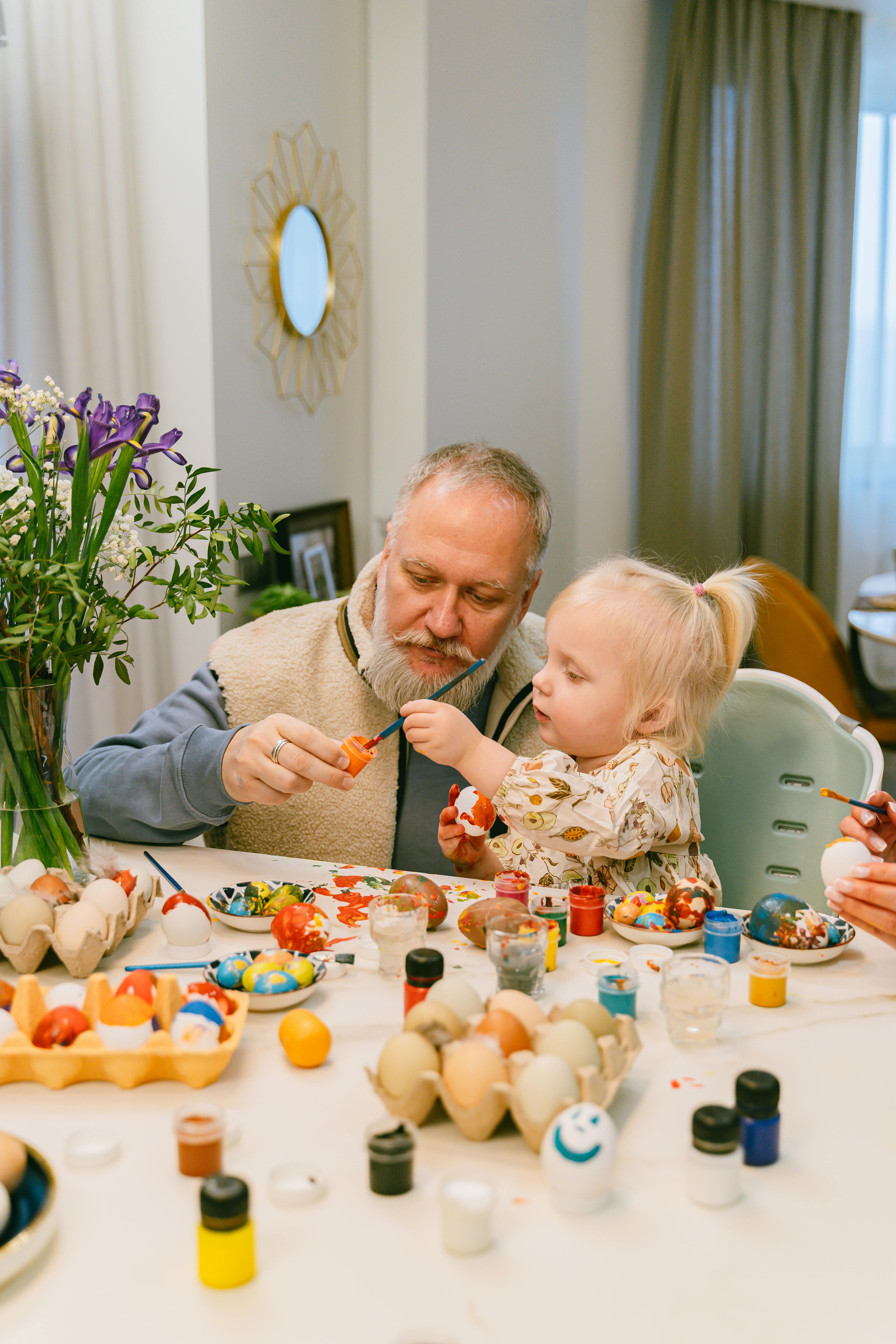 A grandfather playing with his granddaughter | Source: Pexels