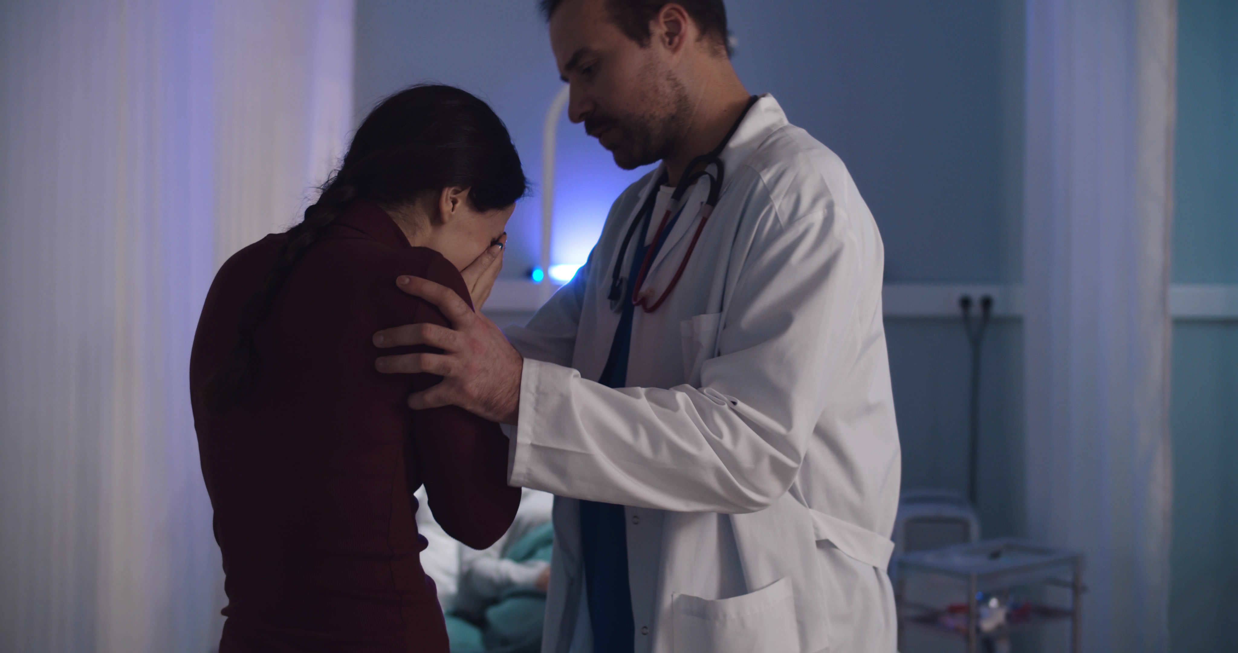 Doctor comforting crying woman | Source: Shutterstock