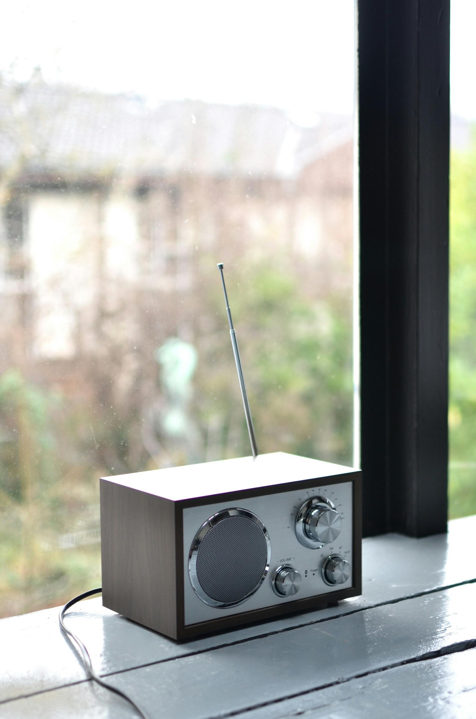 A modern portable radio set on a windowsill | Source: Pexels