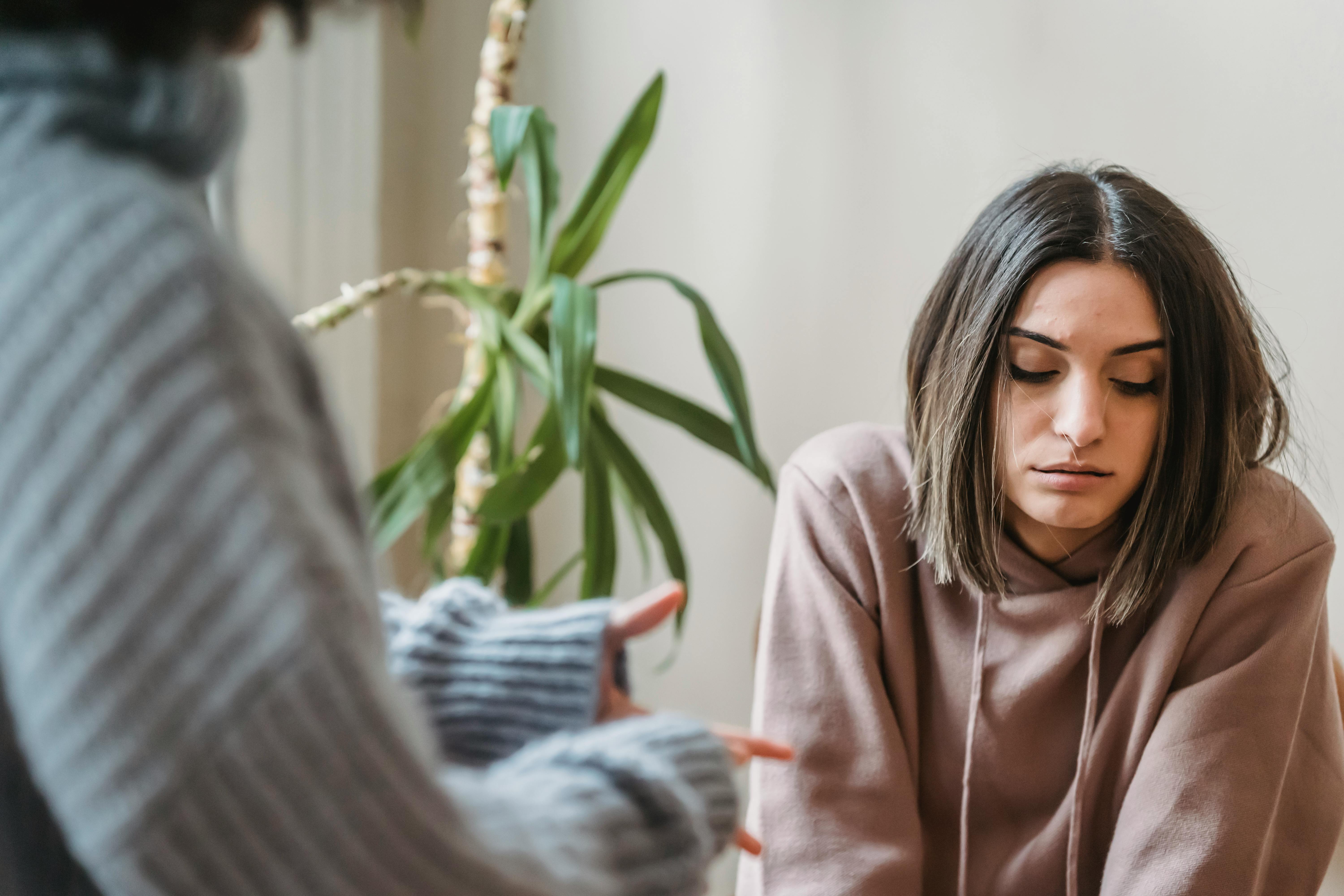 An upset woman listening to someone talk | Source: Pexels
