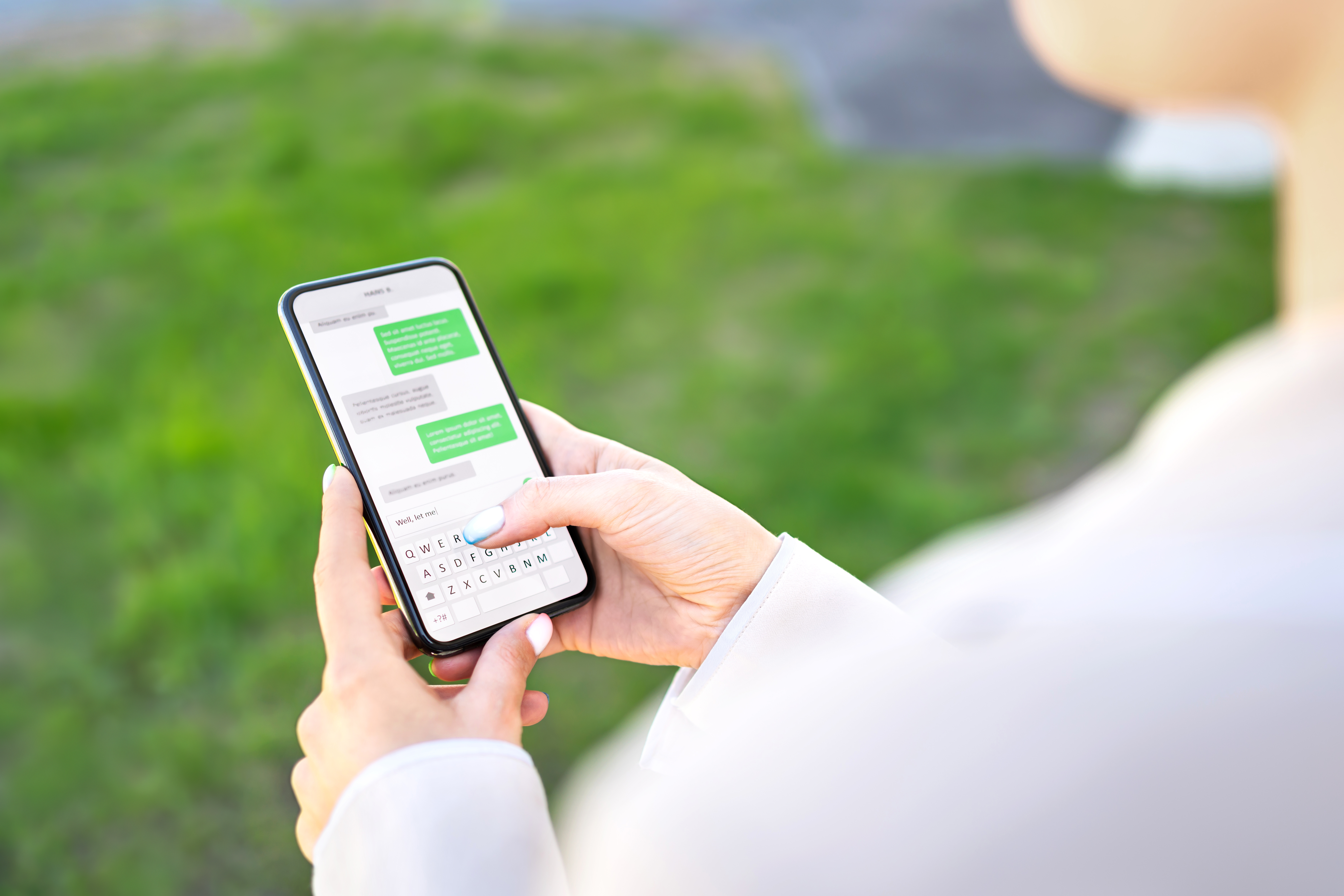 A woman sending a message from her smartphone | Source: Shutterstock