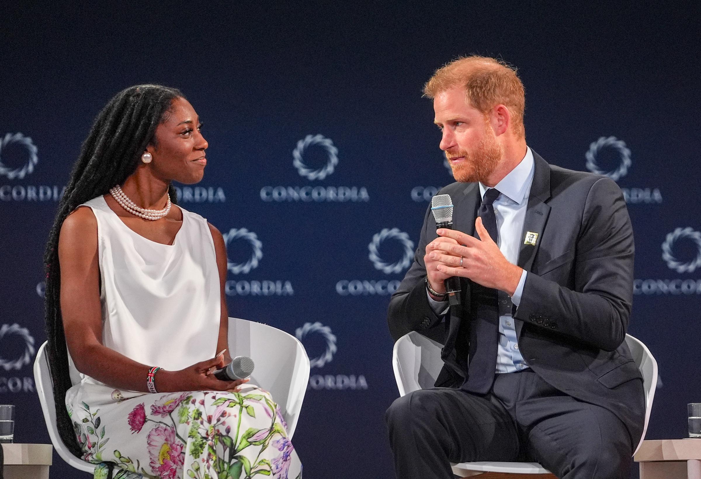 Legacy Award recipient Christina Williams looks on as Prince Harry speaks onstage. | Source: Getty Images