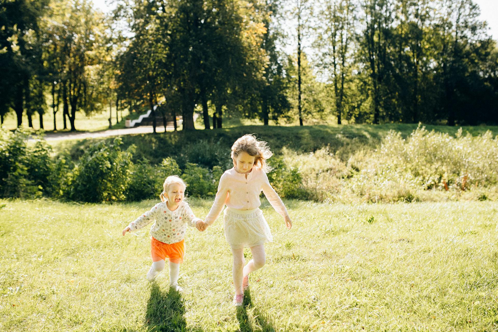 Two girls playing in the garden | Source: Pexels