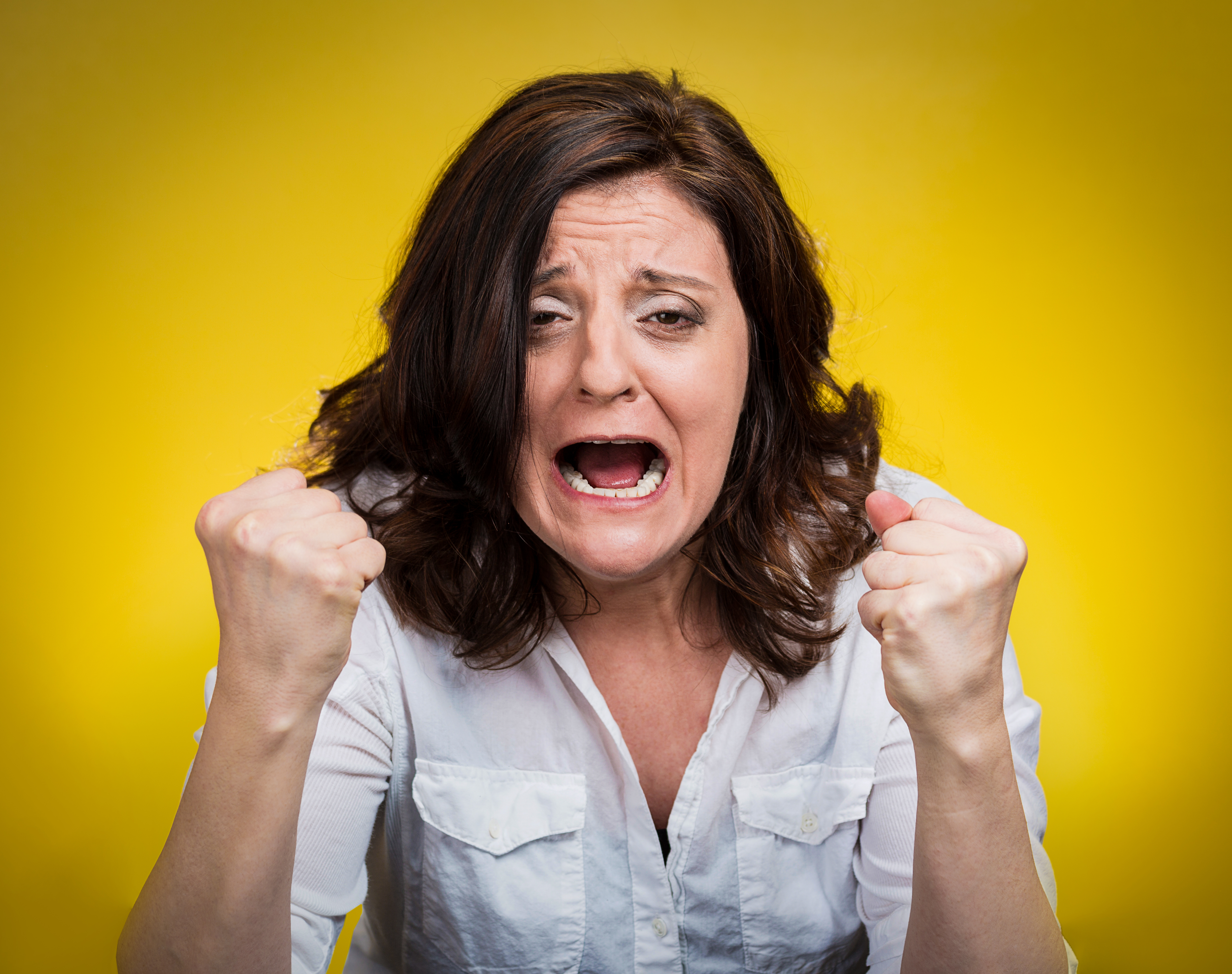 An angry woman screaming | Source: Shutterstock