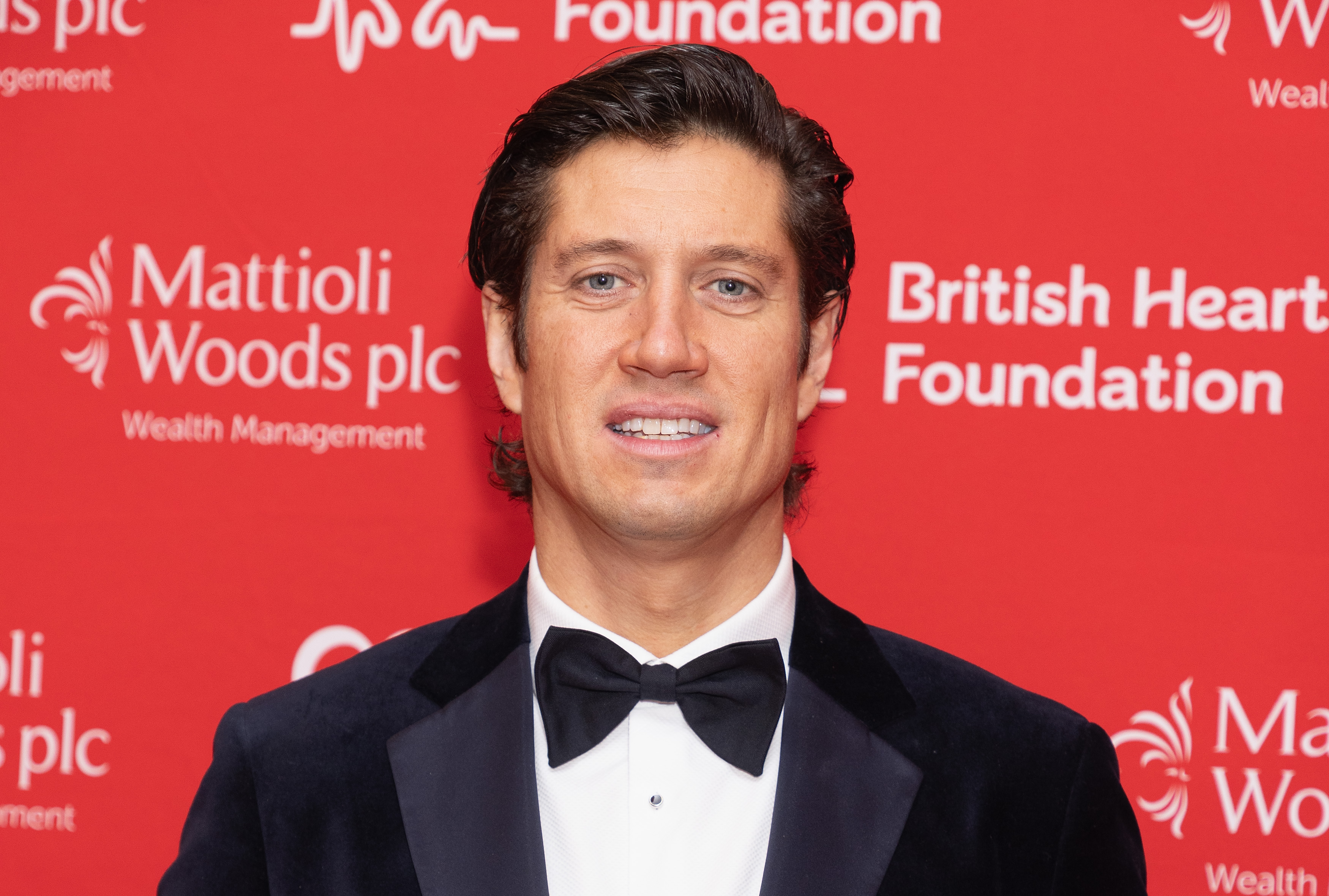 Vernon Kay looks sharp in a black tuxedo with a crisp white shirt and bow tie, offering a polished smile as he attends the Heart Hero Awards in London.