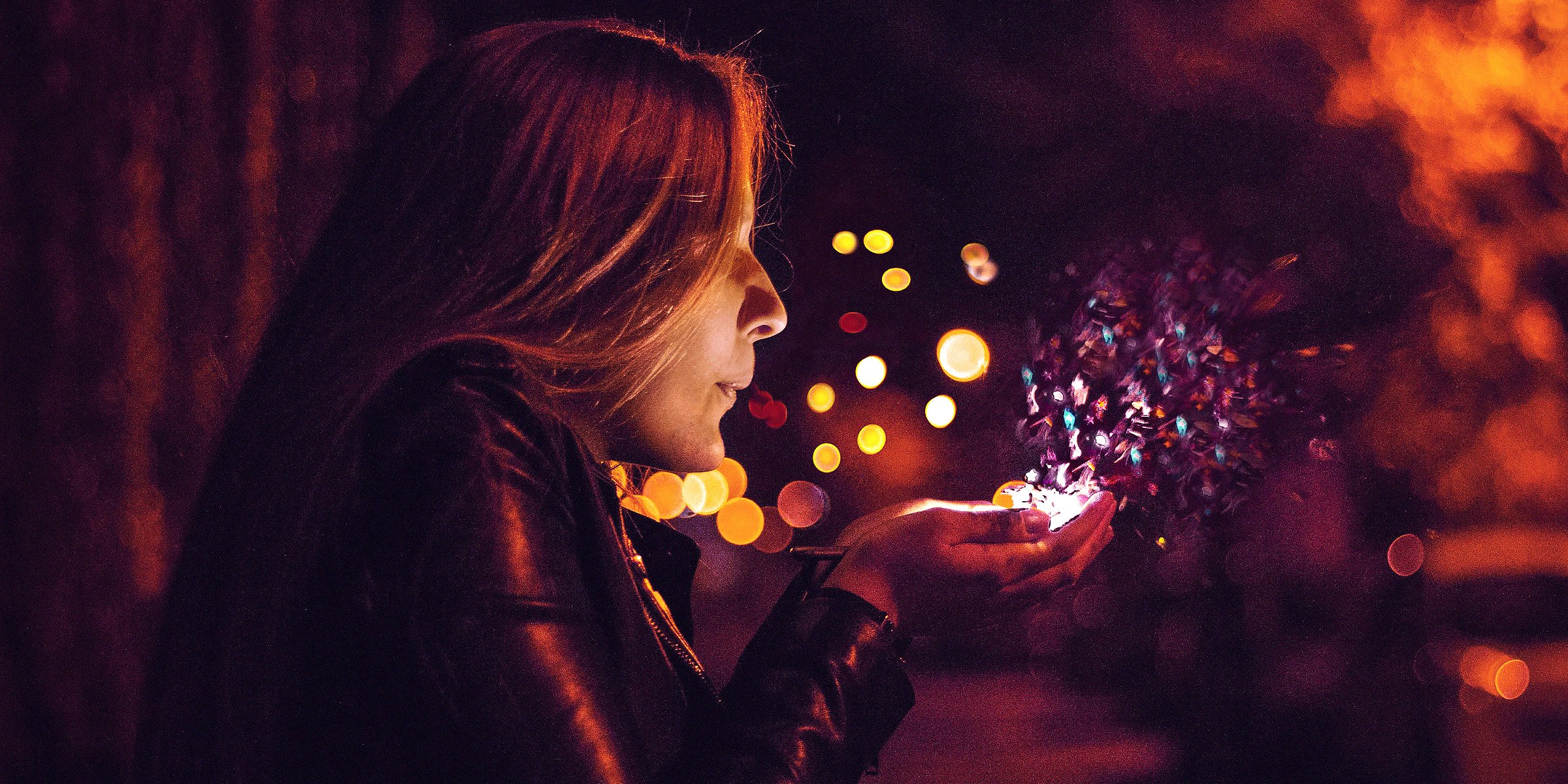 A woman blowing magic out of her hands  | Source: Unsplash