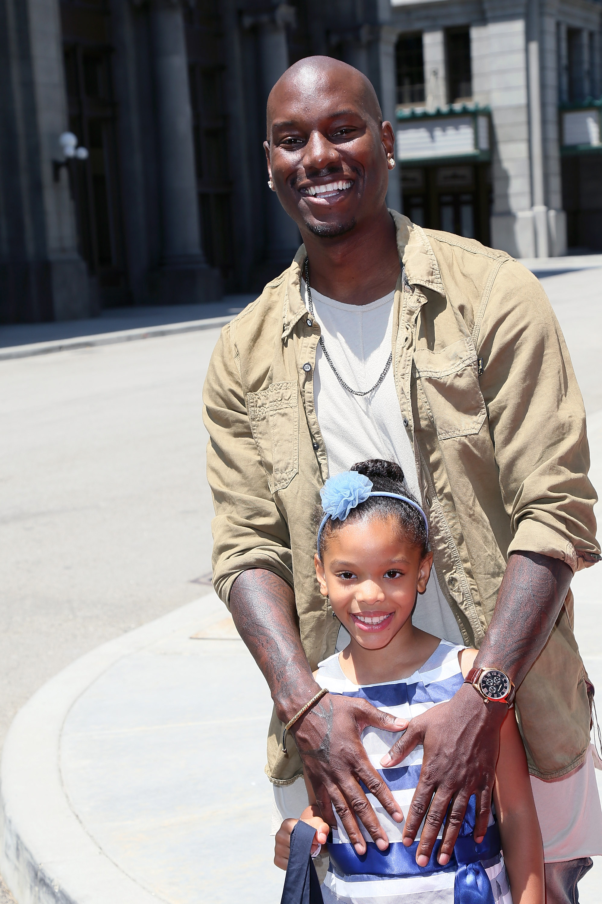 Tyrese Gibson wrapped his hands protectively around Shayla Gibson as the pair smiled for cameras on a sunny day at Universal Studios Hollywood. The father-daughter duo looked relaxed and playful, with Shayla's bright grin matching her dad's cheerful energy.