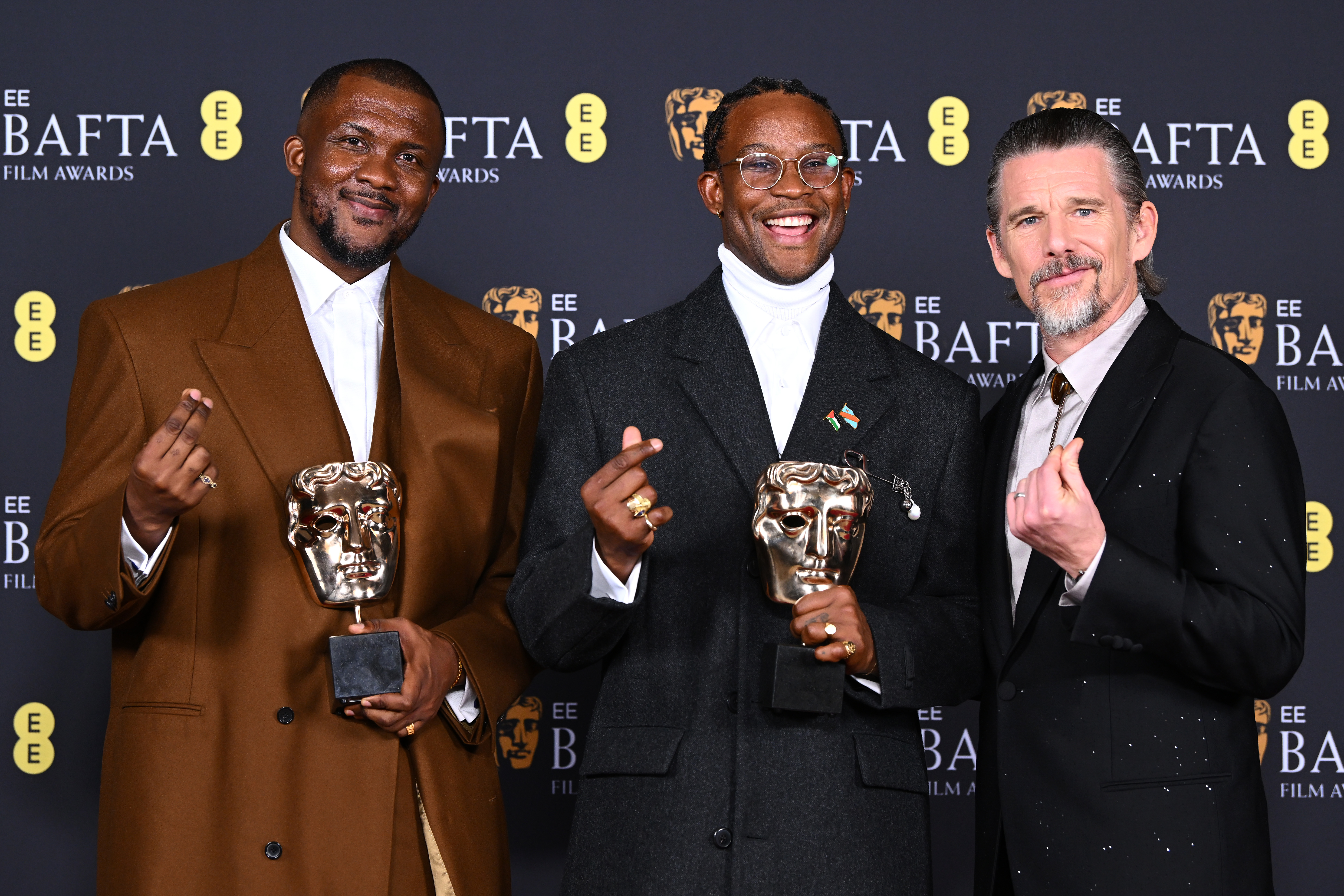 Akinola Davies Jr, Wale Davies, and Ethan Hawke pose with the award for 'My Father's Shadow' during the 79th BAFTA Film Awards at The Royal Festival Hall on February 22, 2026, in London, England | Source: Getty Images