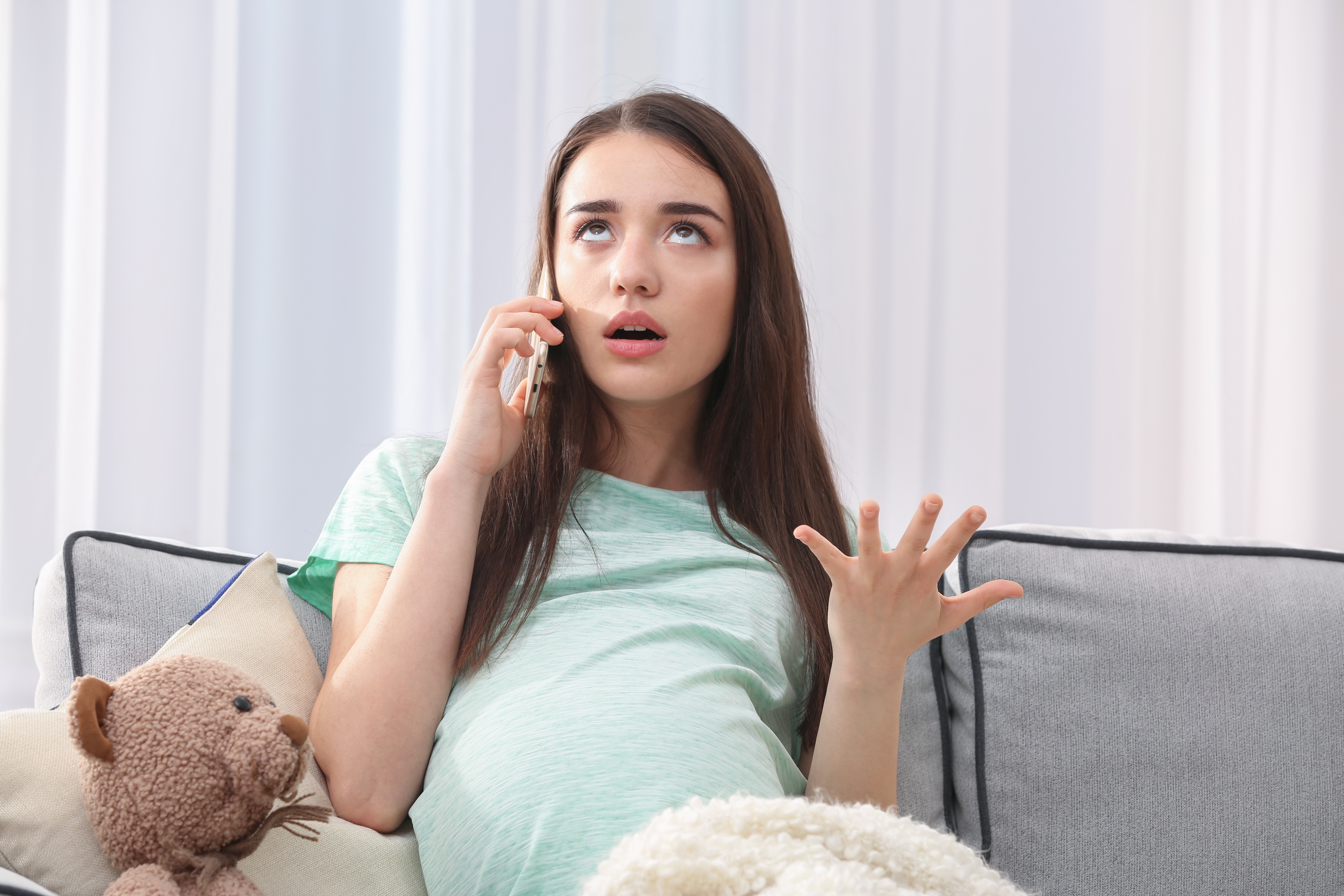 A pregnant woman talking on her phone | Source: Shutterstock
