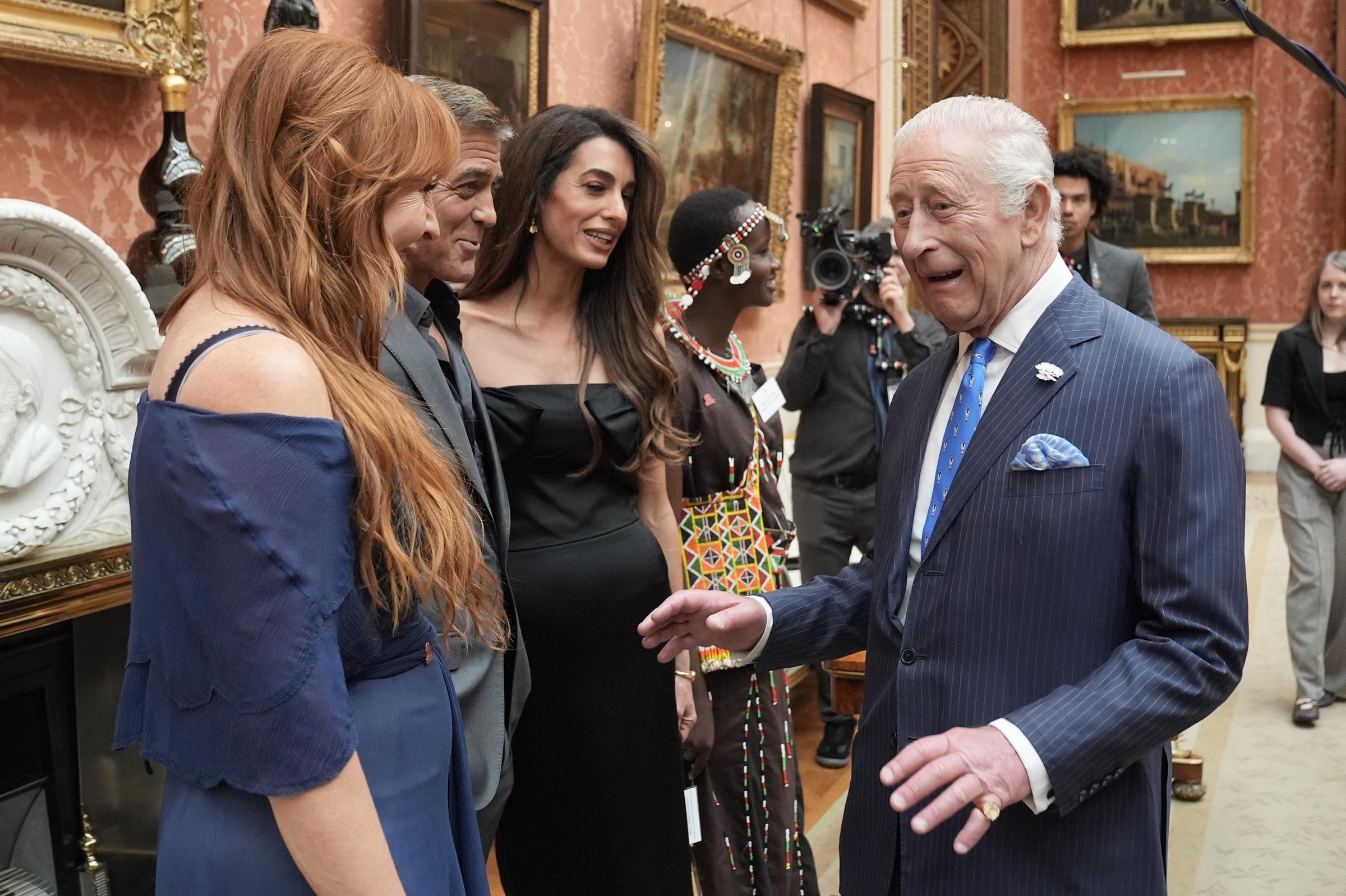 King Charles III speaks with (left to right) Charlotte Tilbury, George, and Amal Clooney during a reception for the winners of the King's Trust Awards 2025 | Source: Getty Images