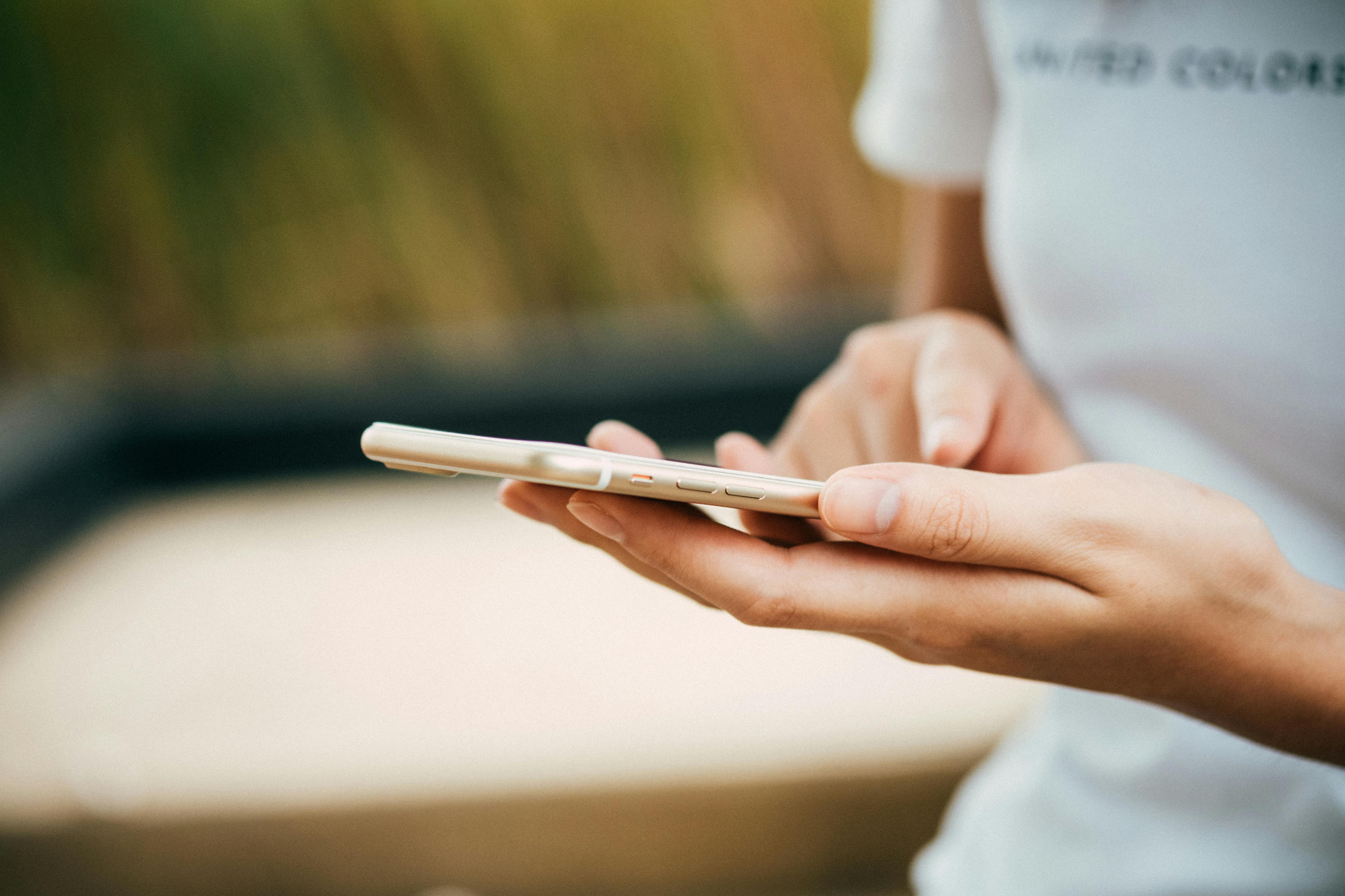 A woman holding a phone in her hands | Source: Pexels