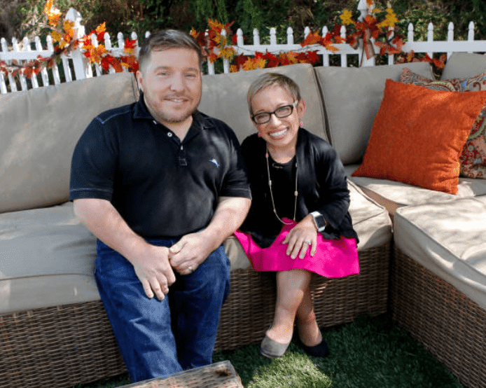 Bill Klein and Dr. Jennifer Arnold sit down for an outdoor interview on the set of Hallmark's "Home and Family," at Universal Studios Hollywood, on September 27, 2017, in Universal City, California | Source: Tibrina Hobson/Getty Images