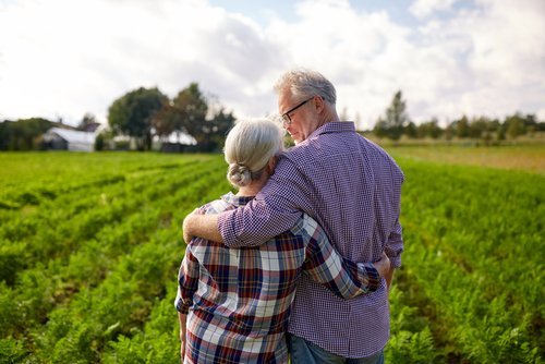 A retired couple looking over their farm. | Source: Shutterstock.