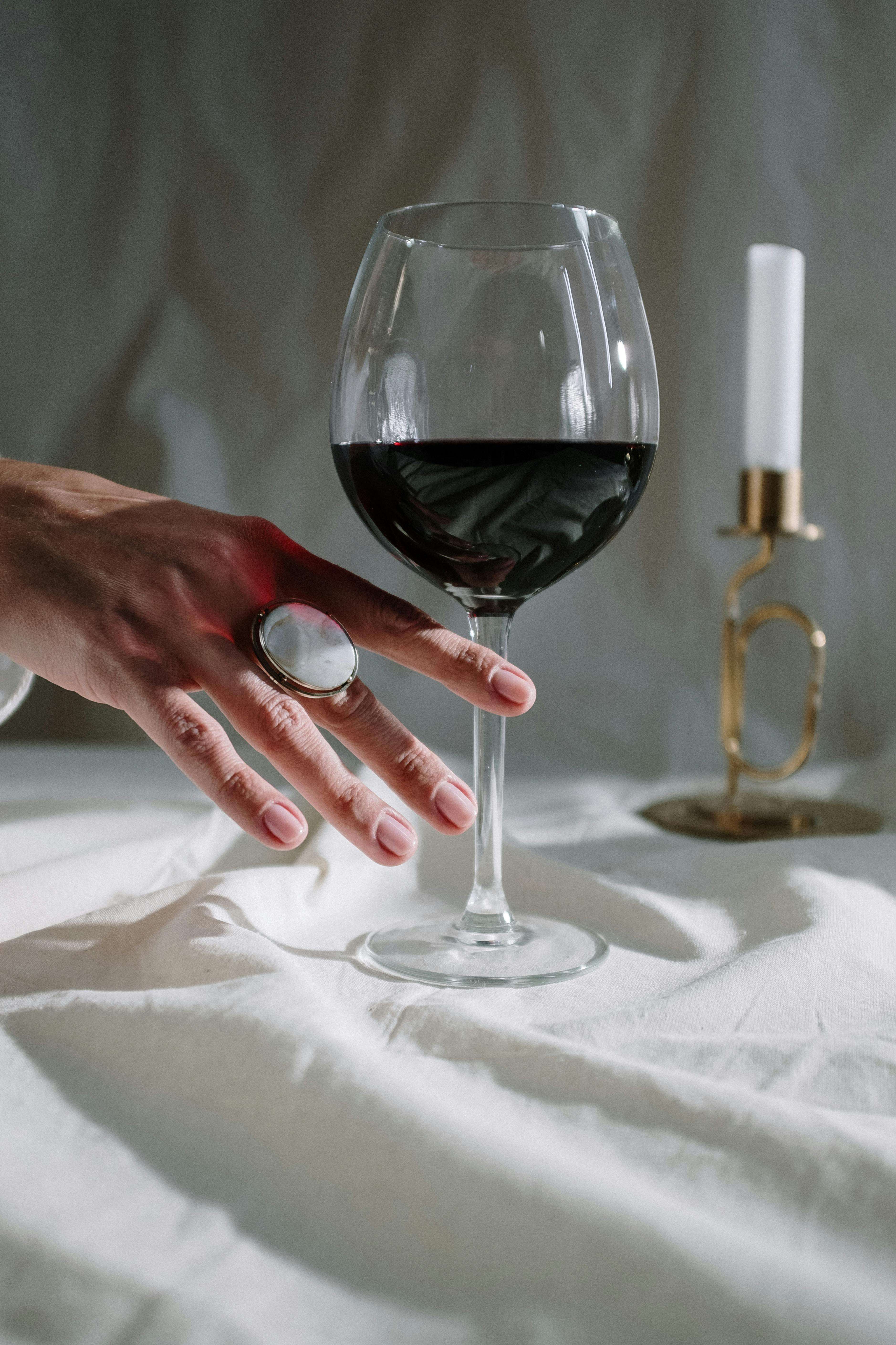 A glass of wine on a table | Source: Pexels