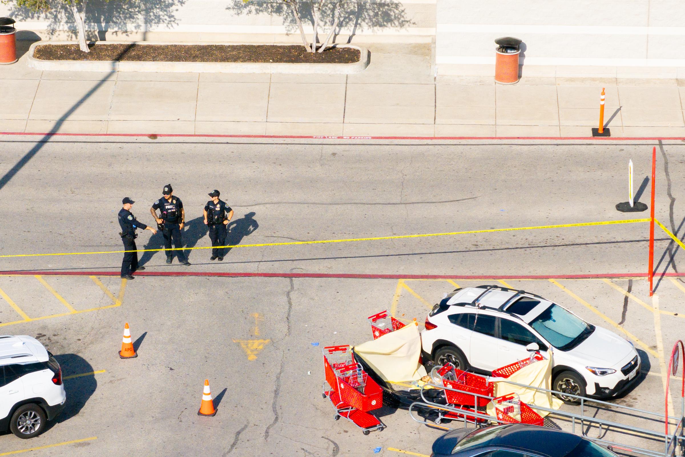 Law enforcement officers secure the scene outside a Target store in north Austin, Texas, on August 11, 2025, after a gunman opened fire in the parking lot, killing three people | Source: Getty Images