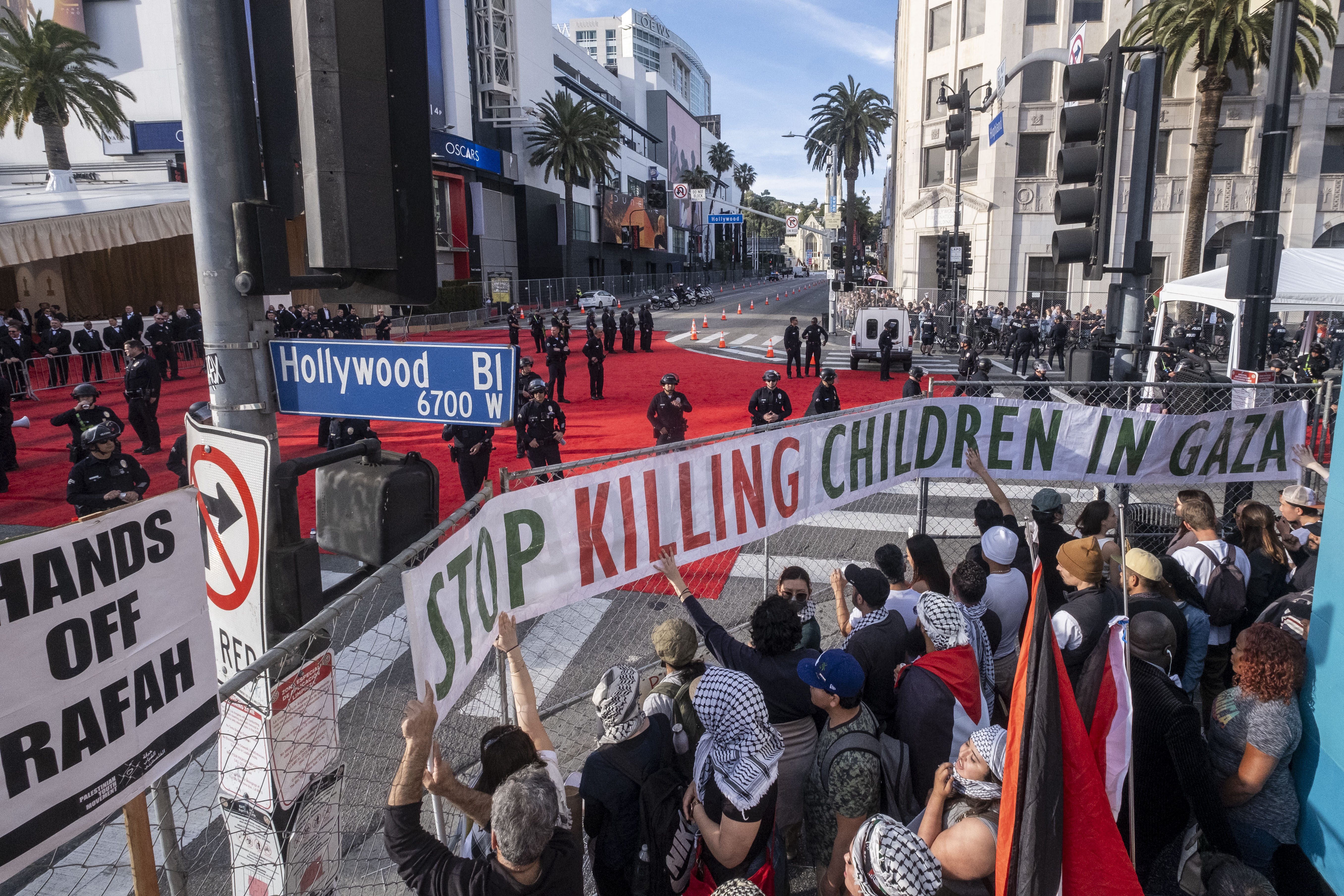 Police officers stand guard at the red carpet area as demonstrators protest in support of Palestinians near the Dolby Theatre during the 96th Academy Awards in Los Angeles, California on March 10, 2024 | Source: Getty Images