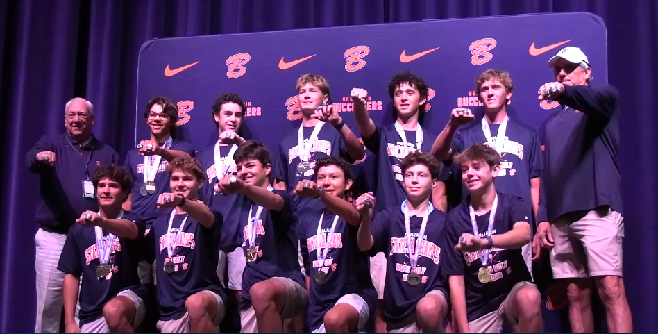 The coaches and Benjamin Buccaneers posing together for a team photo at the ring ceremony event, posted on February 25, 2026. | Source: YouTube/ESPN West Palm