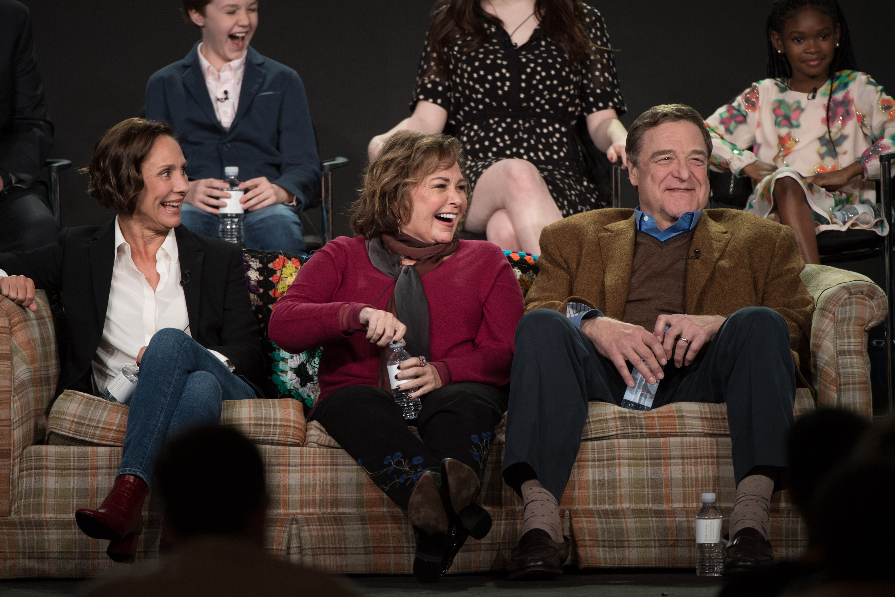 The cast, Laurie Metcalf, the celeb, and John Goodman, of "Roseanne" address the press at Disney in 2018 for the reboot | Source: Getty Images