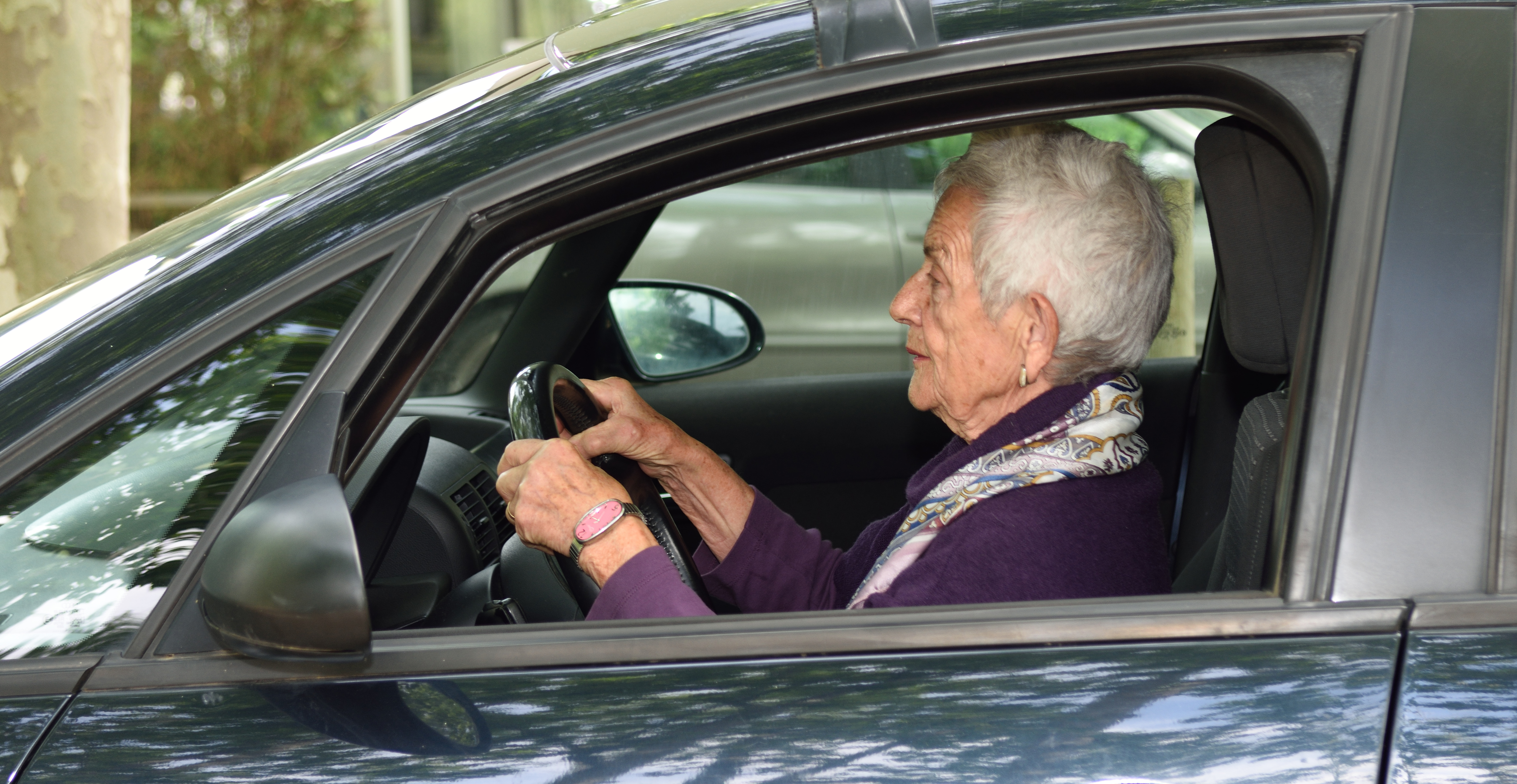 A senior woman driving a car | Source: Shutterstock