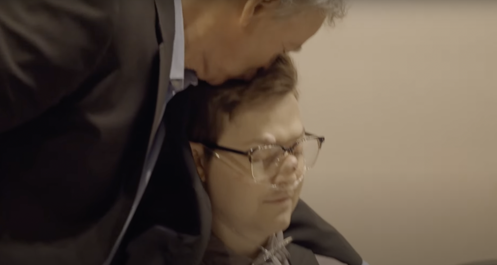 Gary Sinise planting a kiss on his son Mac Sinise's head. | Source: YouTube/Mac Sinise