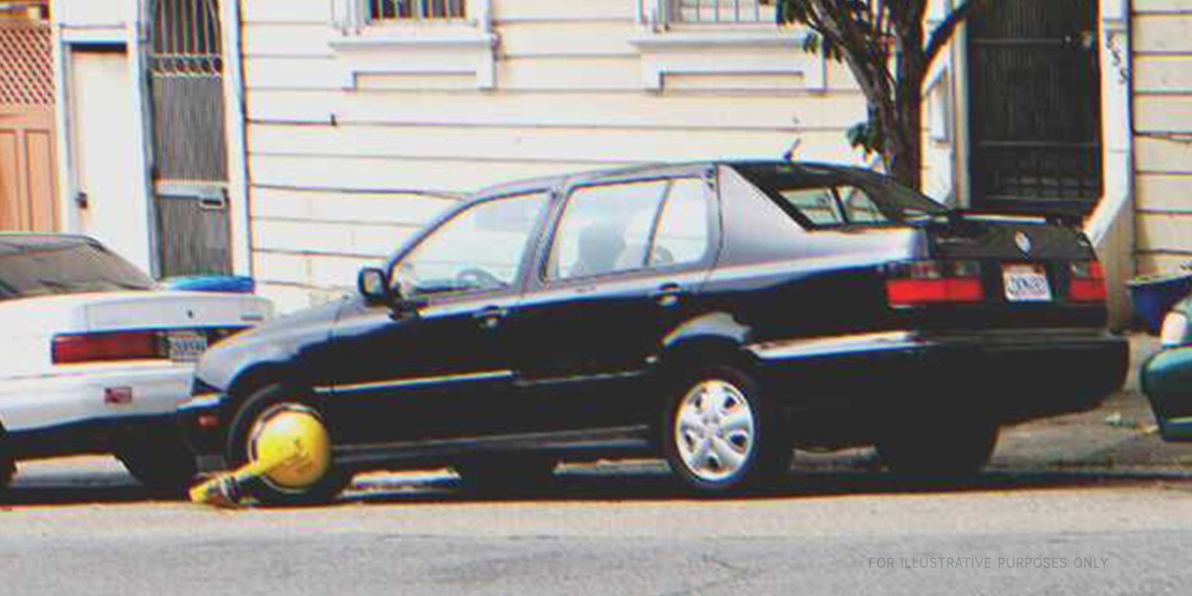 Car with wheel lock on street. | Flickr / ecastro (CC BY 2.0)