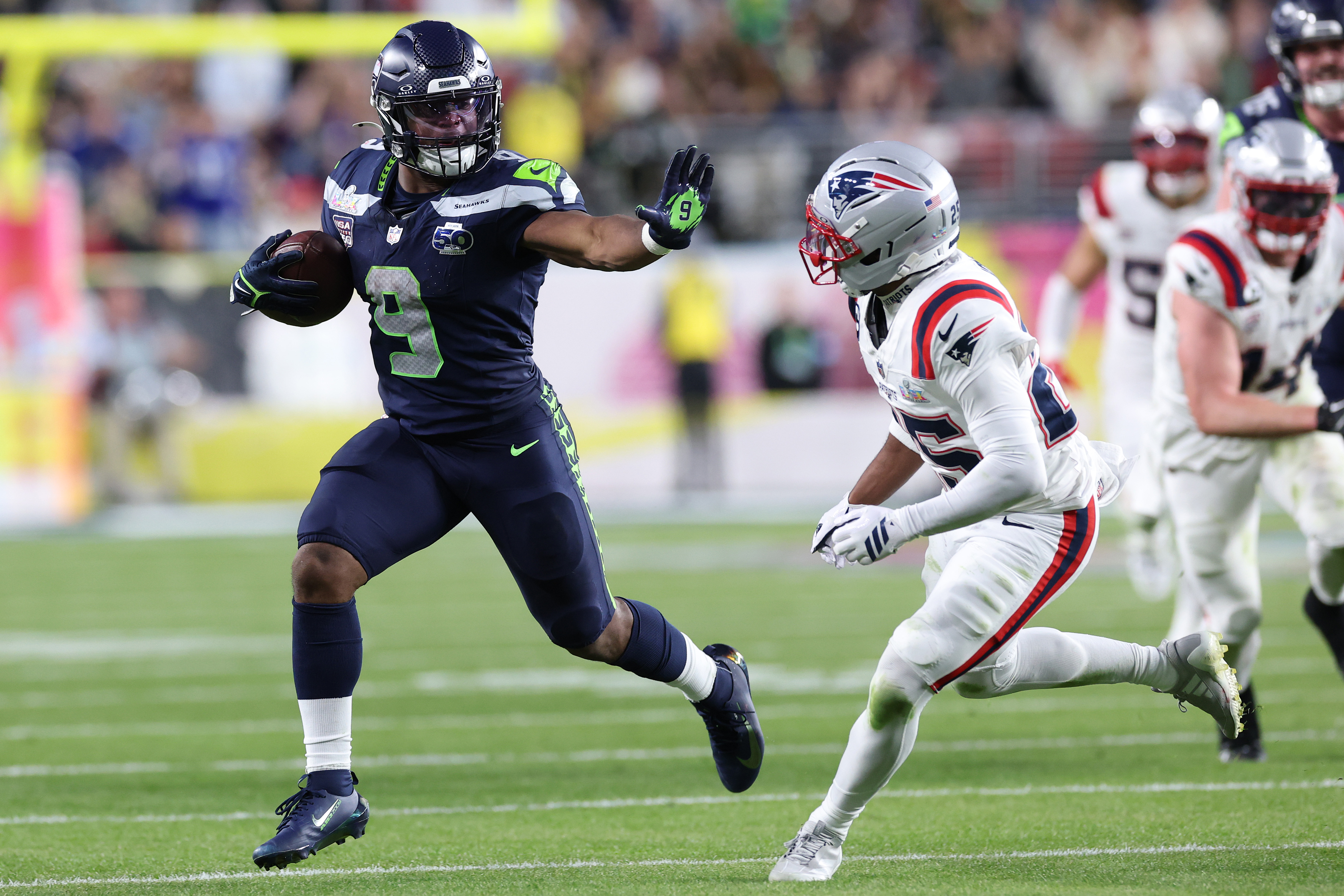 Seattle Seahawks running back Kenneth Walker III runs past New England Patriots cornerback Marcus Jones during Super Bowl LX | Source: Getty Images