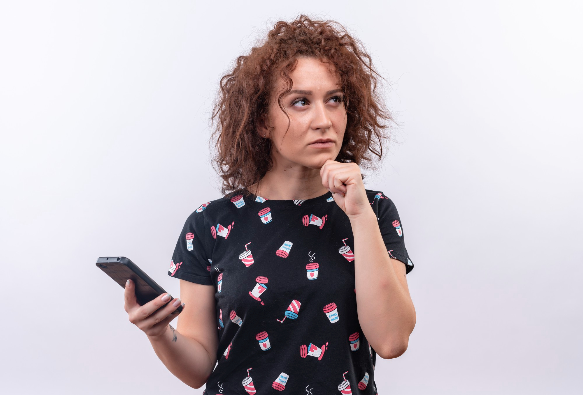 A woman holding a phone and plotting something | Source: Freepik
