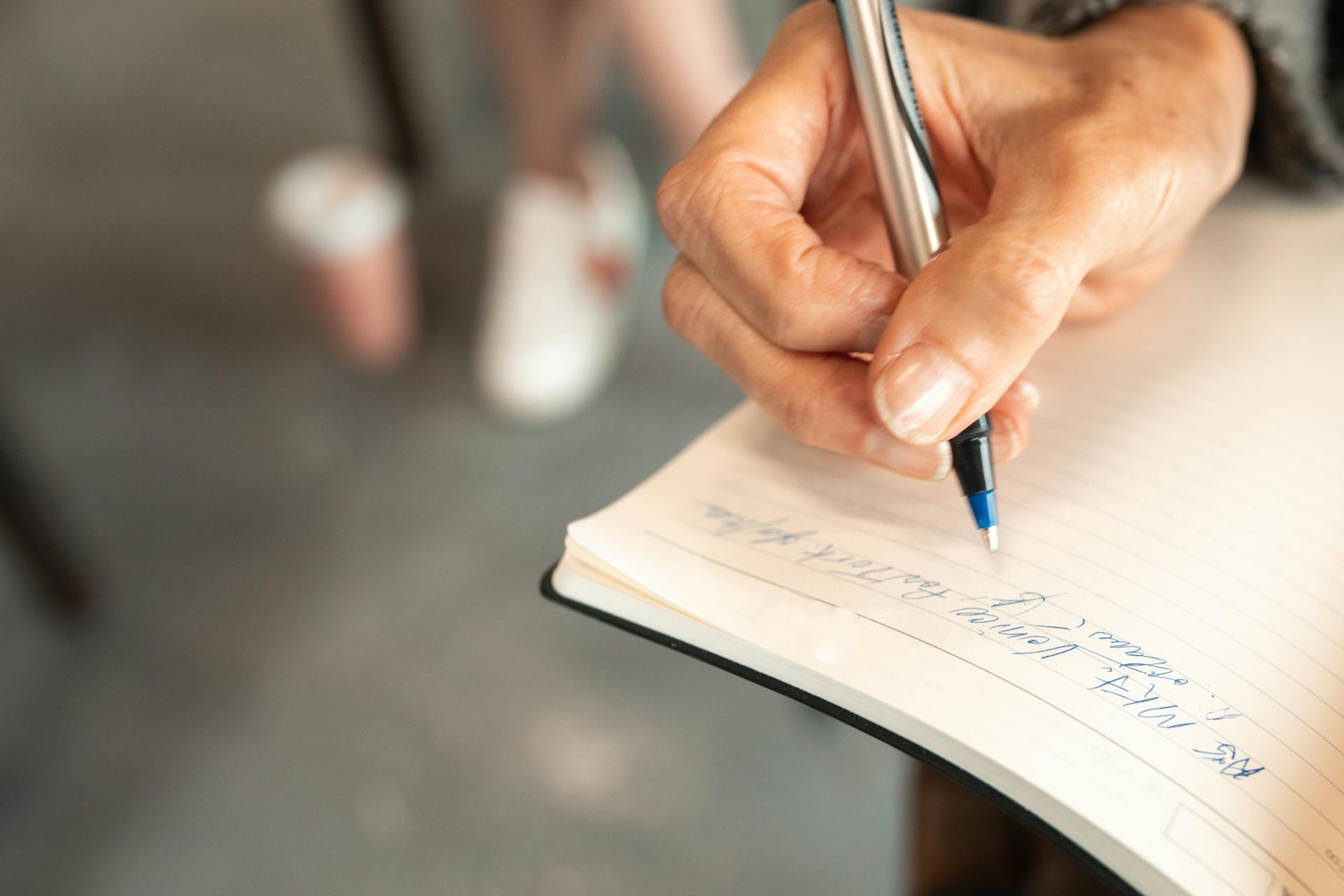 A woman writing in a notebook | Source: Pexels