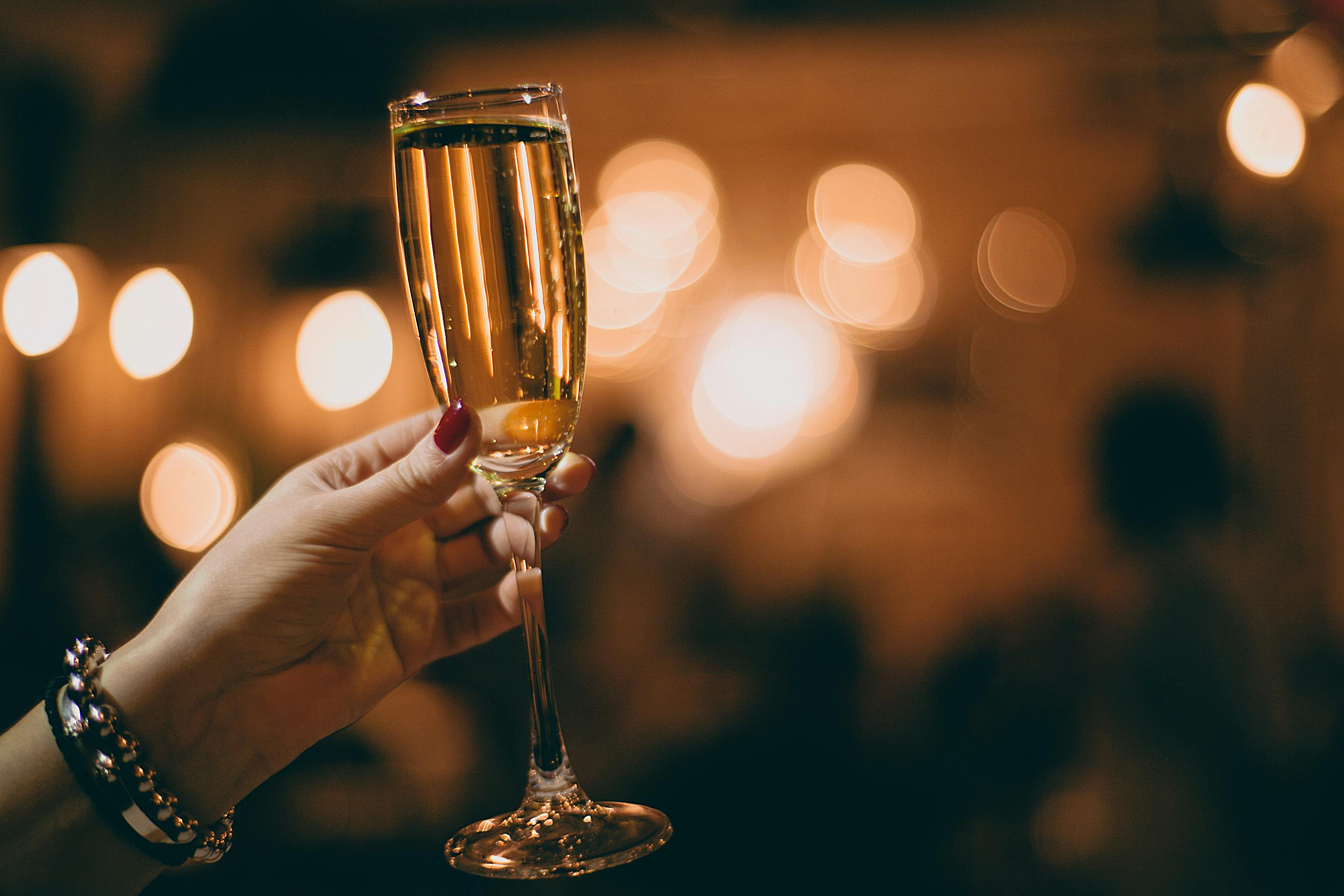 A woman raising her glass for a toast | Source: Pexels