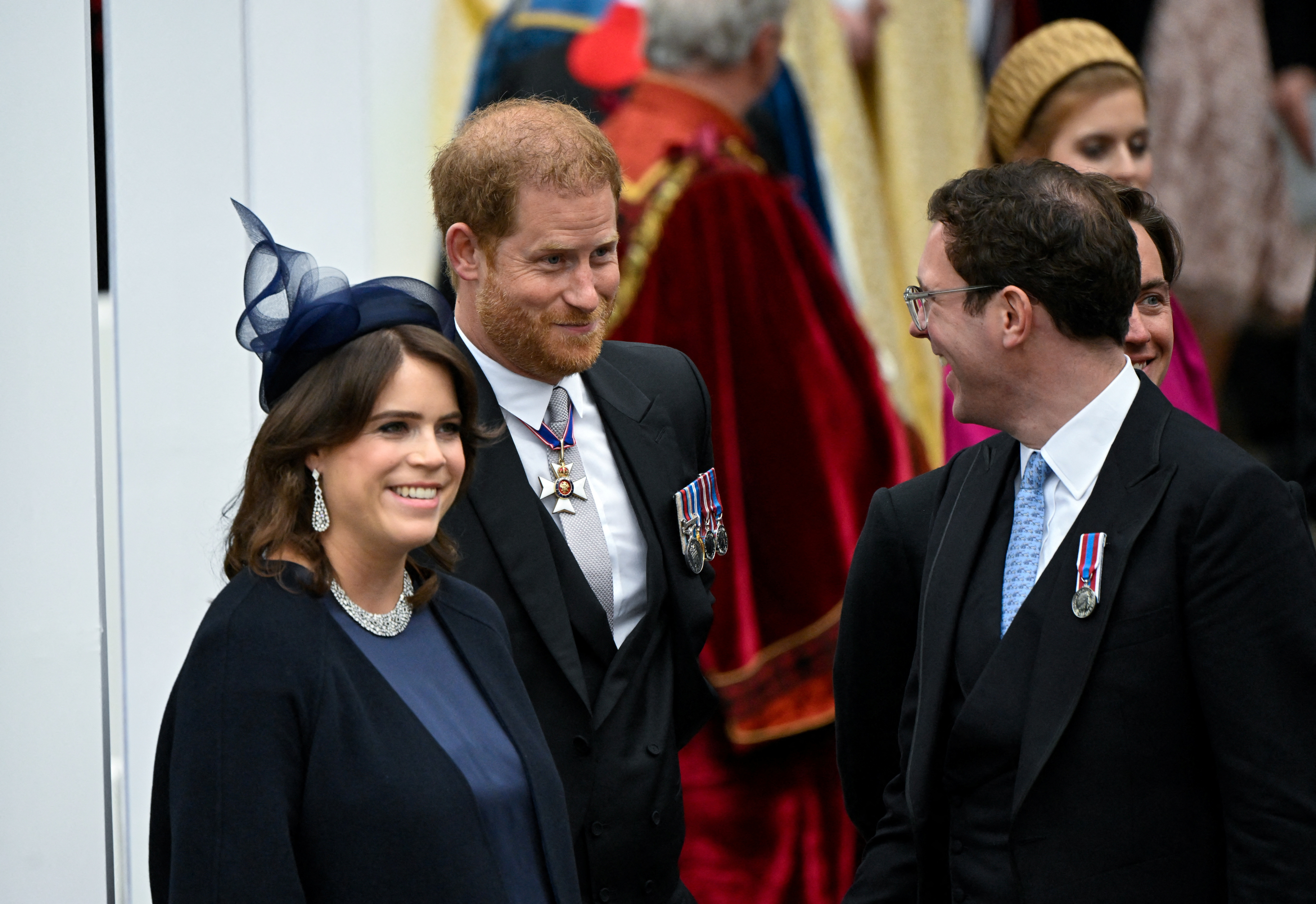 Prince Harry interacting with Princess Eugenie and her husband, Jack Brooksbank, at the Coronation of King Charles III and Queen Camilla in London, England on May 6, 2023 | Source: Getty Images