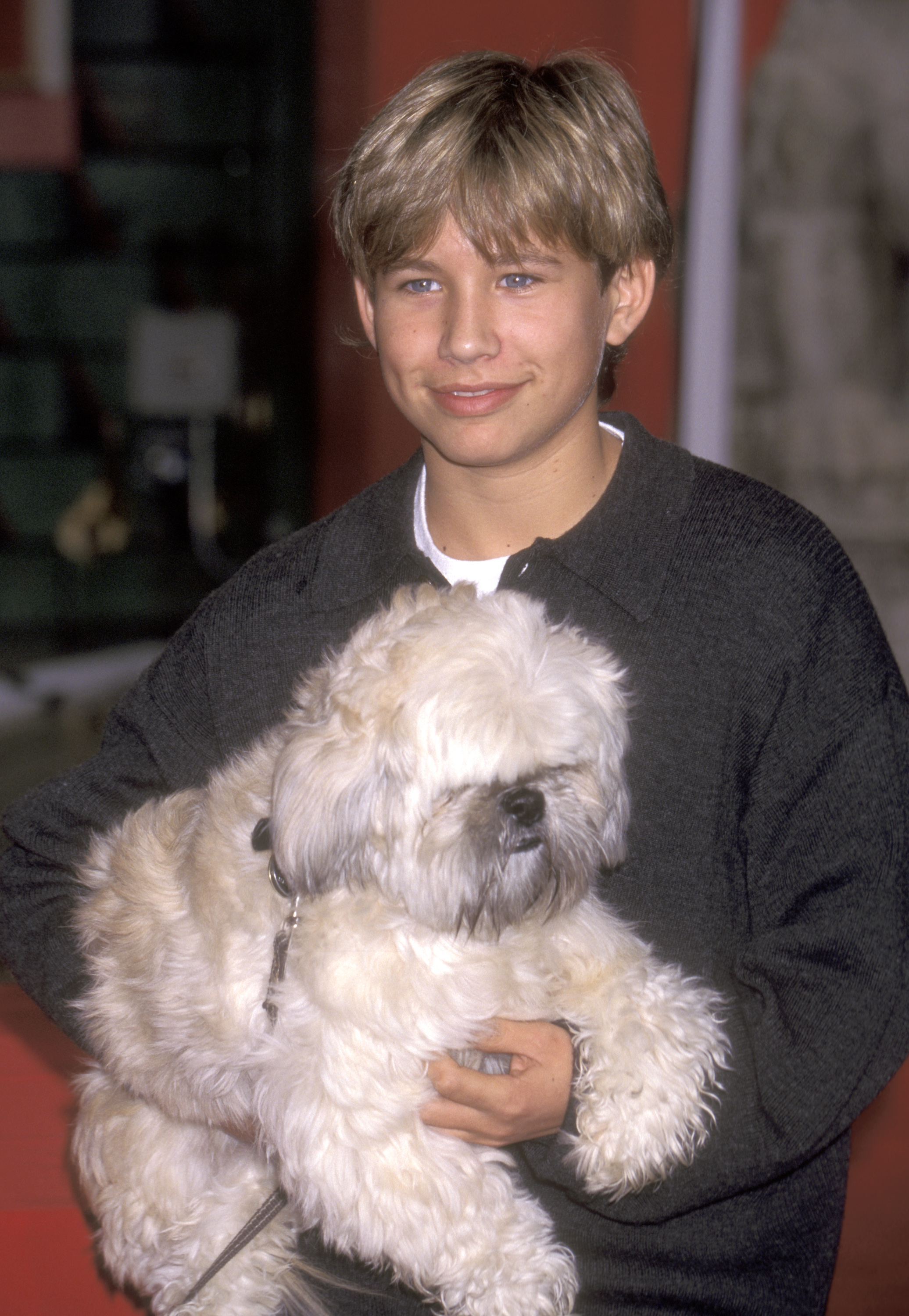 Jonathan Taylor Thomas poses with a fluffy dog during the Second Annual Pawprint Walk of Fame Induction at Mann's Chinese Theatre in Hollywood, California.