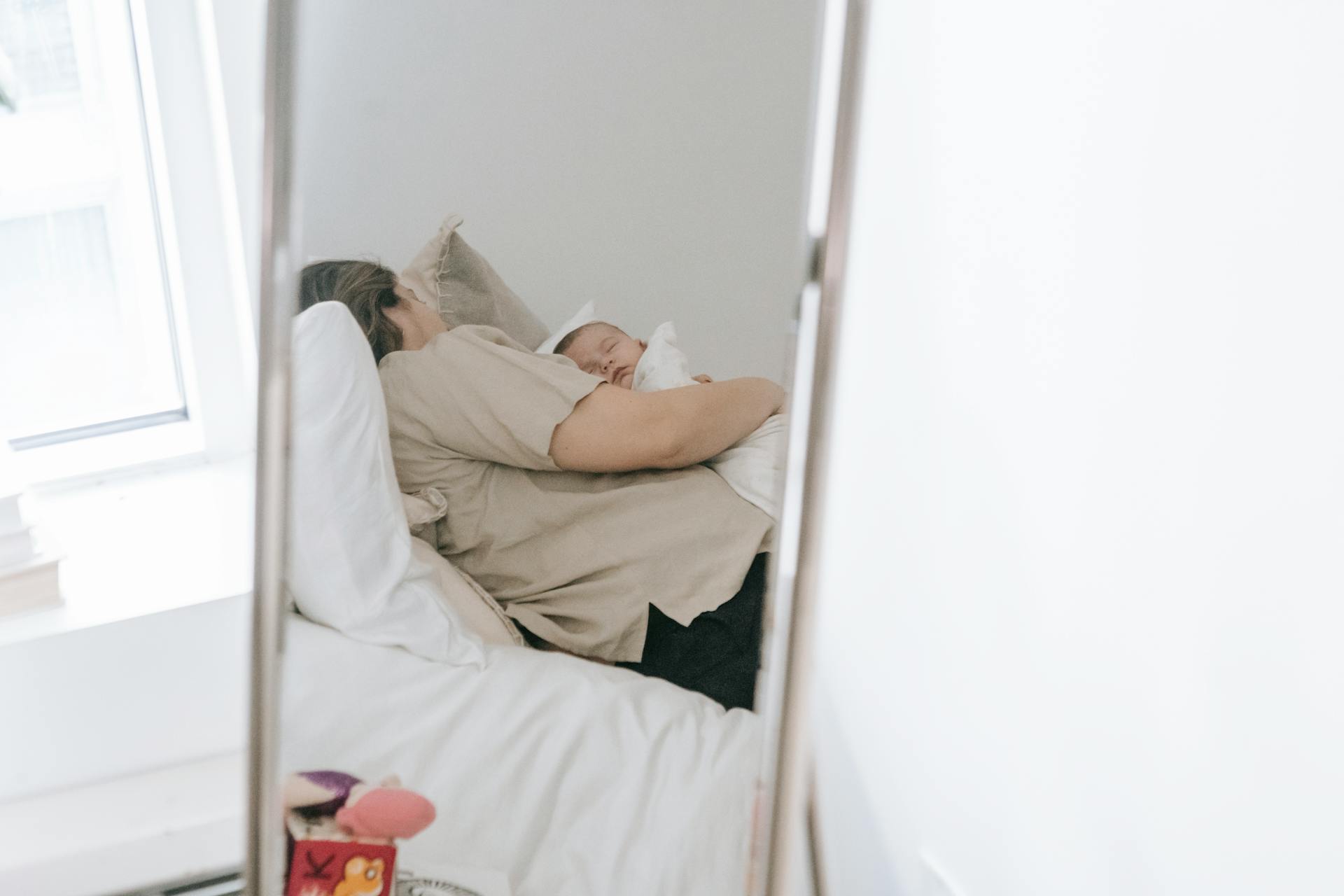 Woman with her baby in bedroom | Source: Pexels