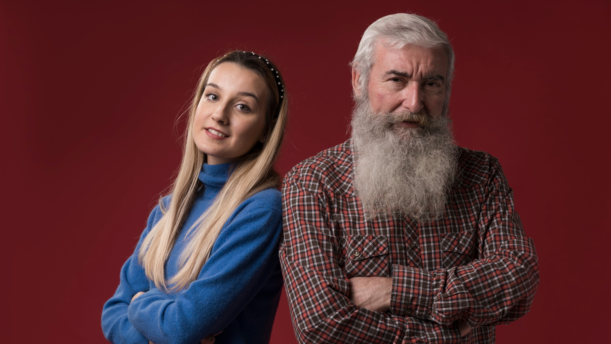 A woman smiling while standing next to her father | Source: Freepik