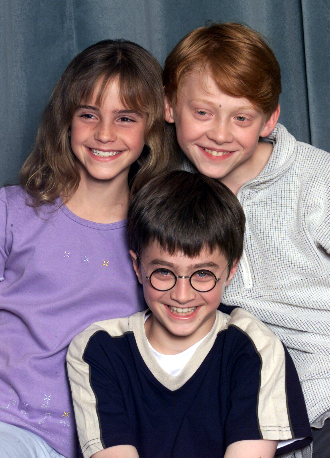 Emma Watson, Rupert Grint, and Daniel Radcliffe are pictured at a photocall to present the new cast of the "Harry Potter" films on August 23, 2000, in London, England | Source: Getty Images