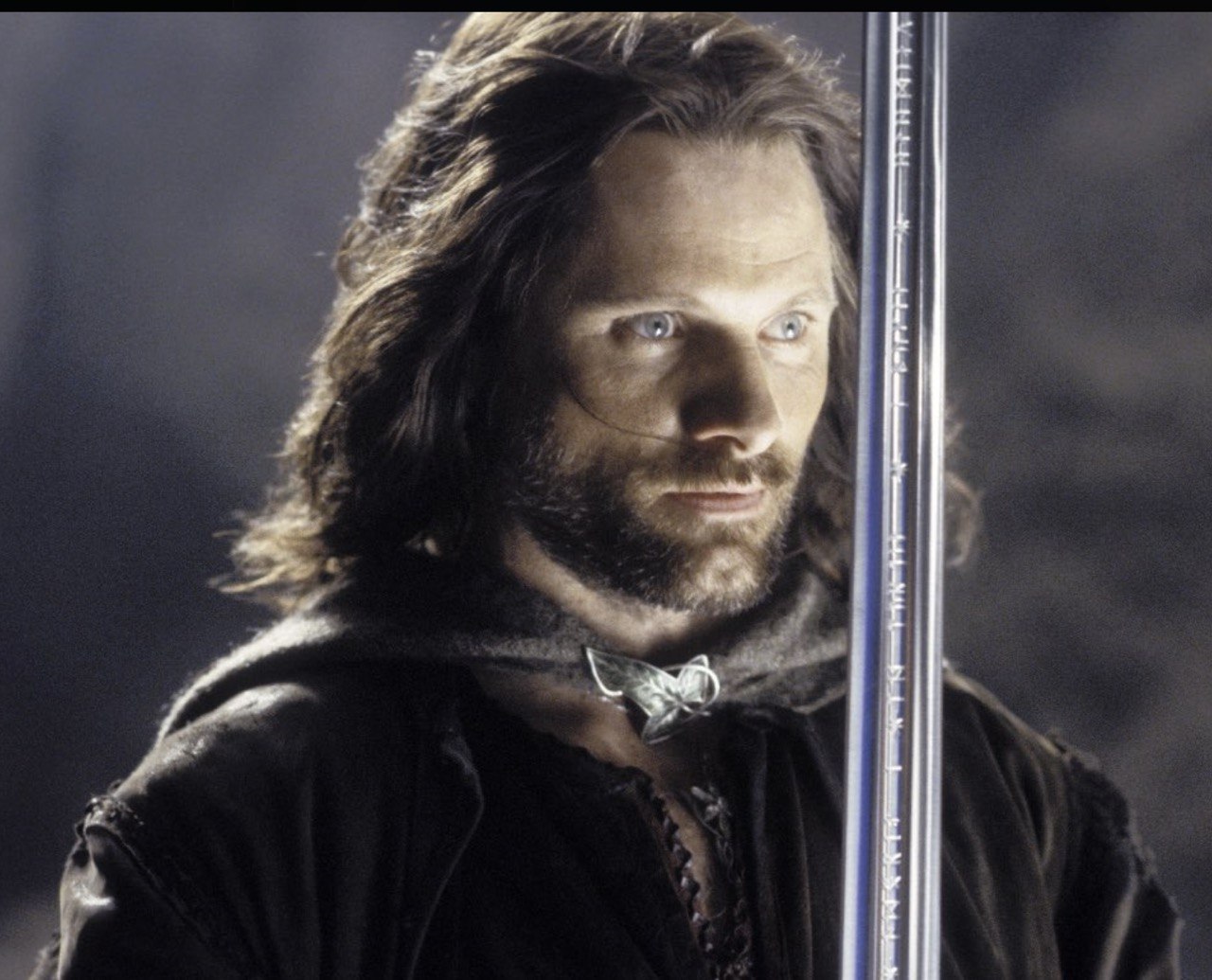 In "The Fellowship of the Ring," Viggo Mortensen portrayed Aragorn, the ranger of the North destined to reclaim the throne of Gondor. With his rugged presence, weather-worn cloak and sword in hand, Mortensen brought a quiet intensity to the role, embodying a reluctant leader on the path to becoming a king. | Source: The Fellowship of the Ring