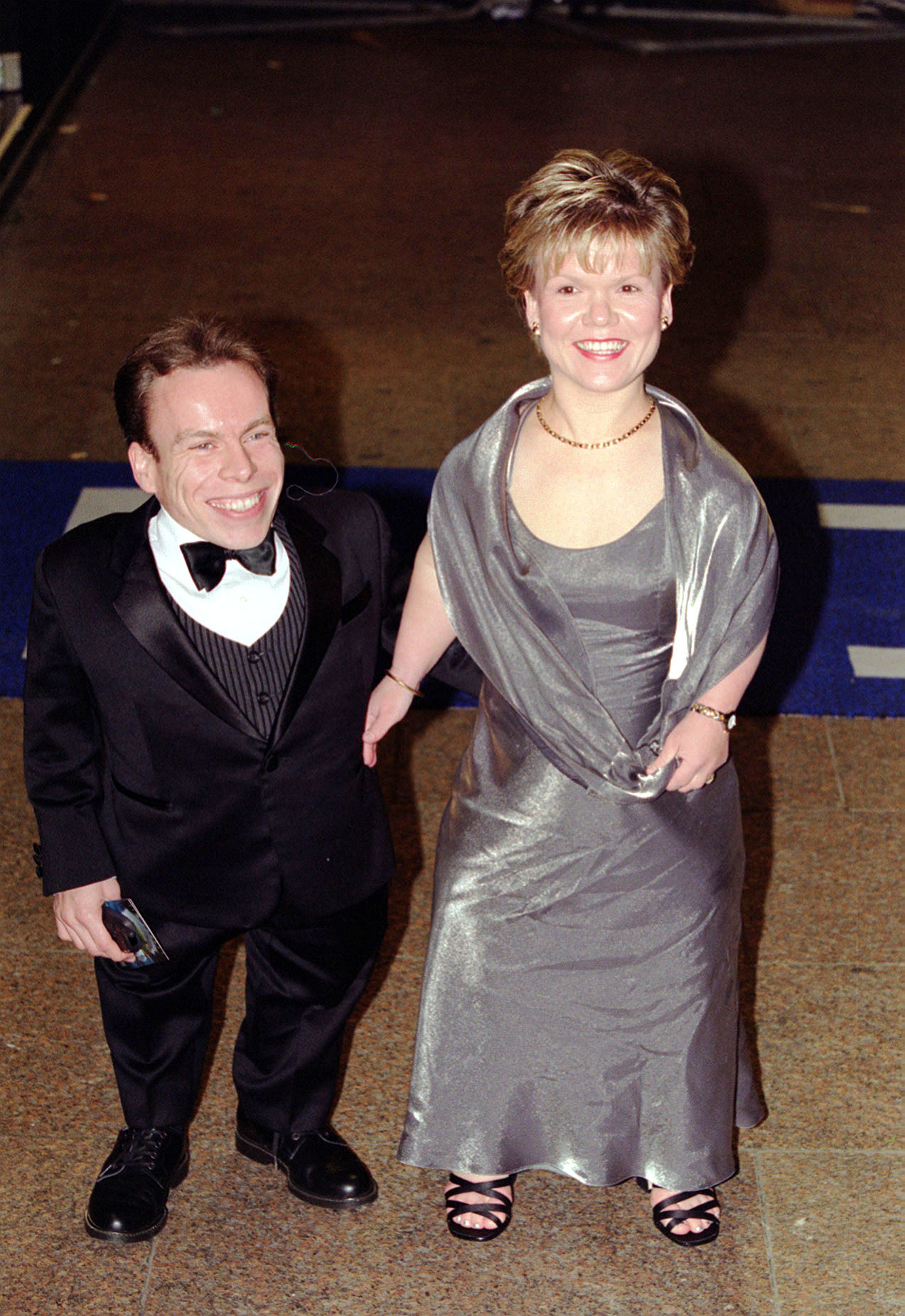 Warwick Davis and his wife Samantha arriving for the premiere of the film "The Grinch" at the Odeon Leicester Square cinema on 15 November 2000 in London, England. | Source: Getty Images